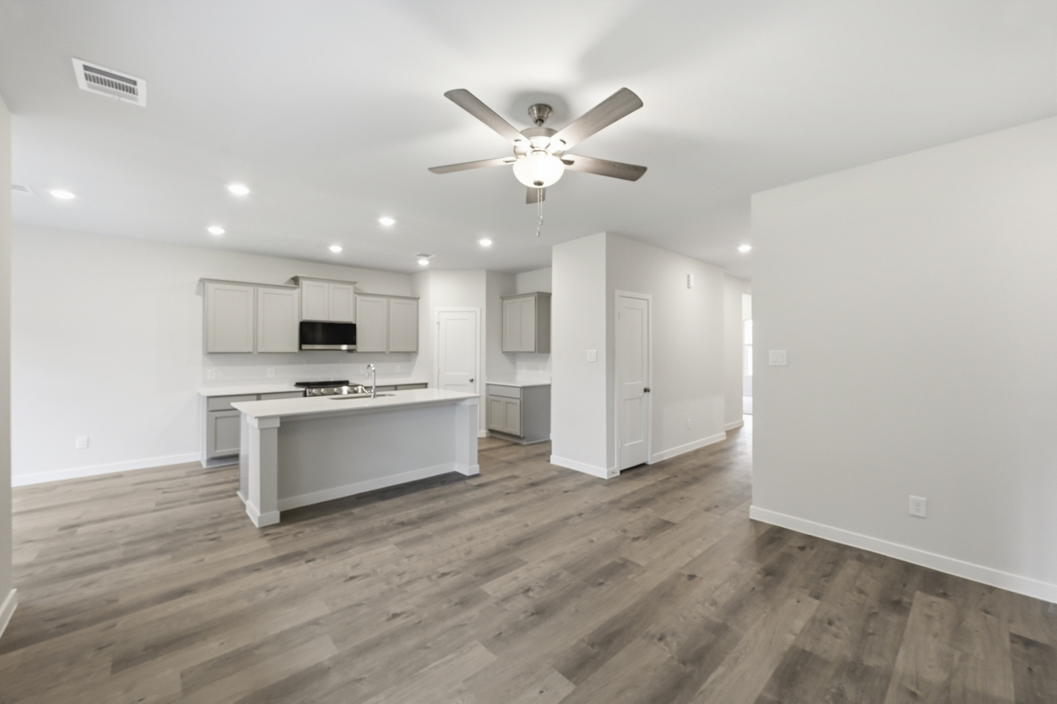 A kitchen with white cabinets.