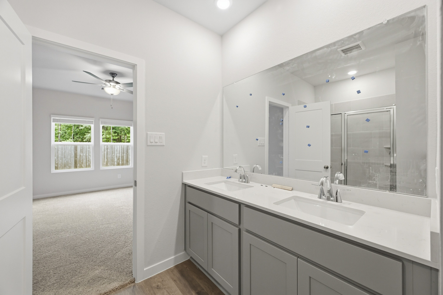 A bathroom with a large mirror.
