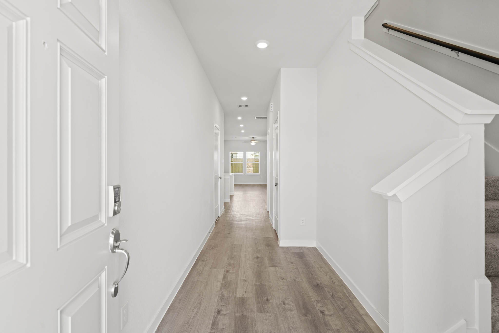 A hallway with white doors.