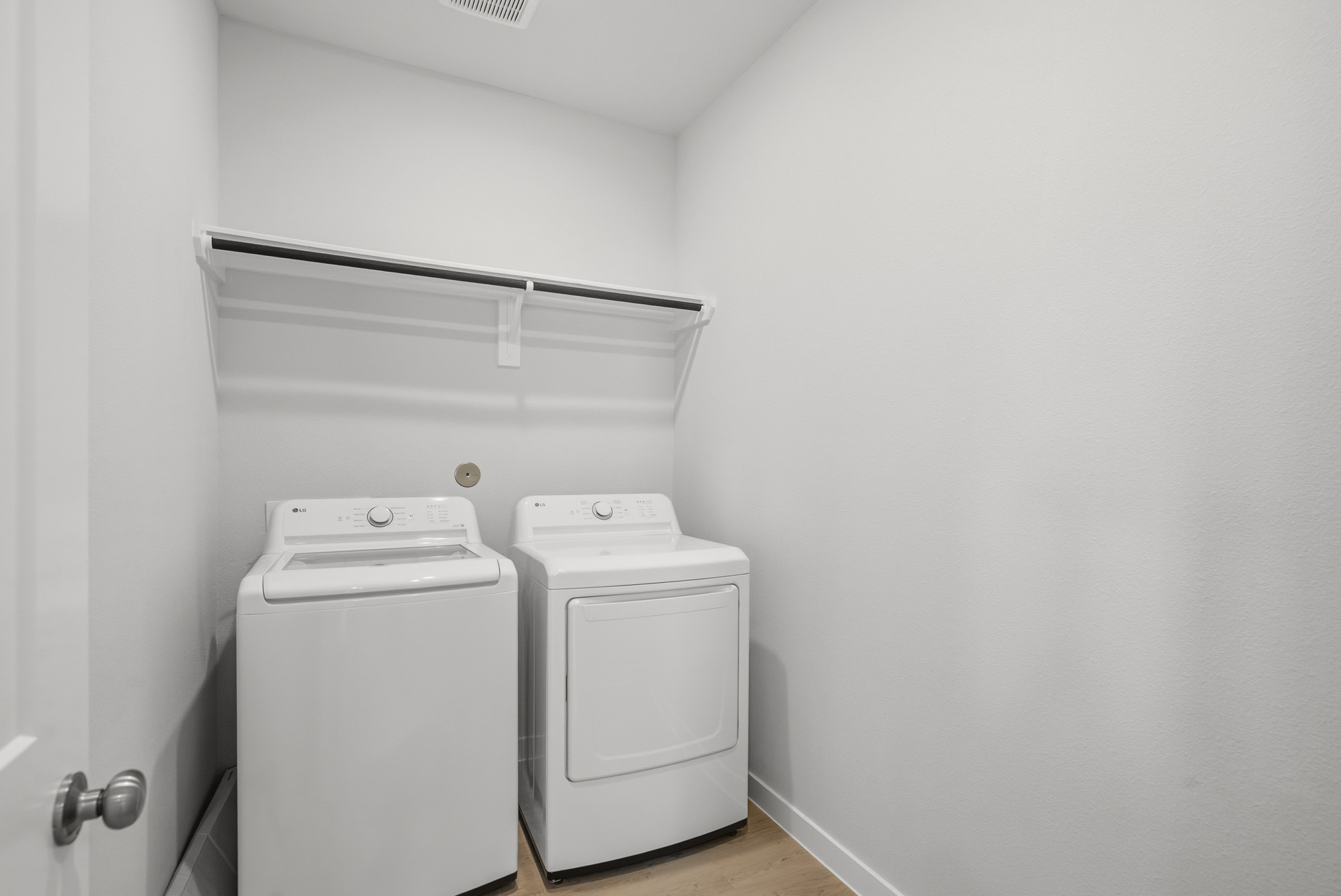 A washing machine and dryer in a room.