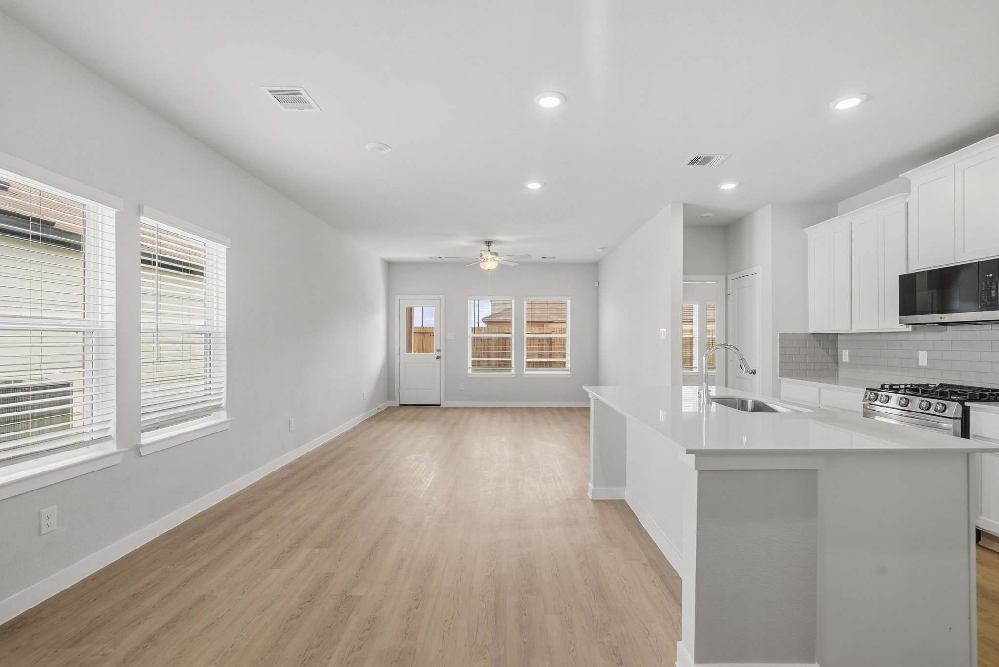 A kitchen with white cabinets.