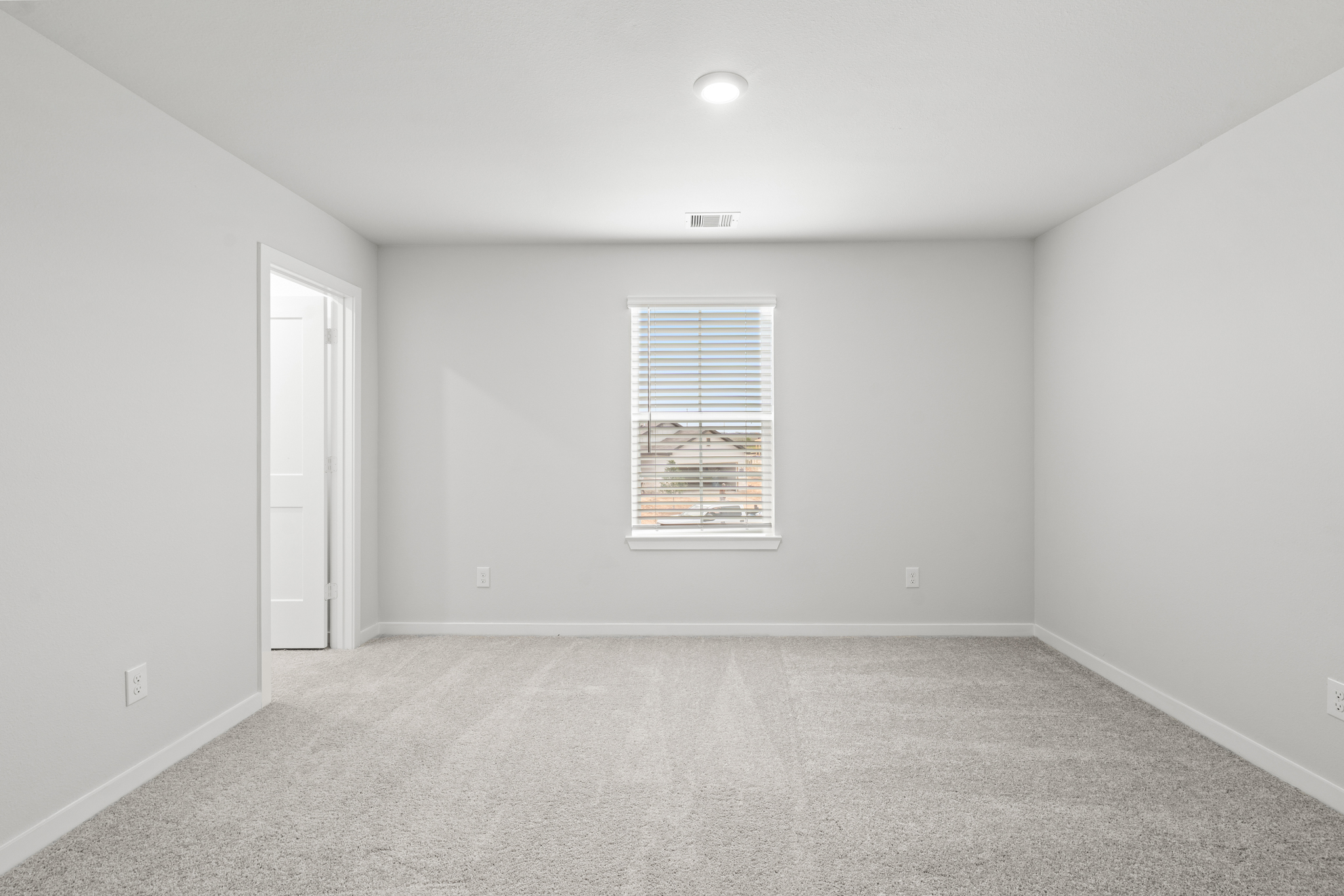 A room with a window and a door.