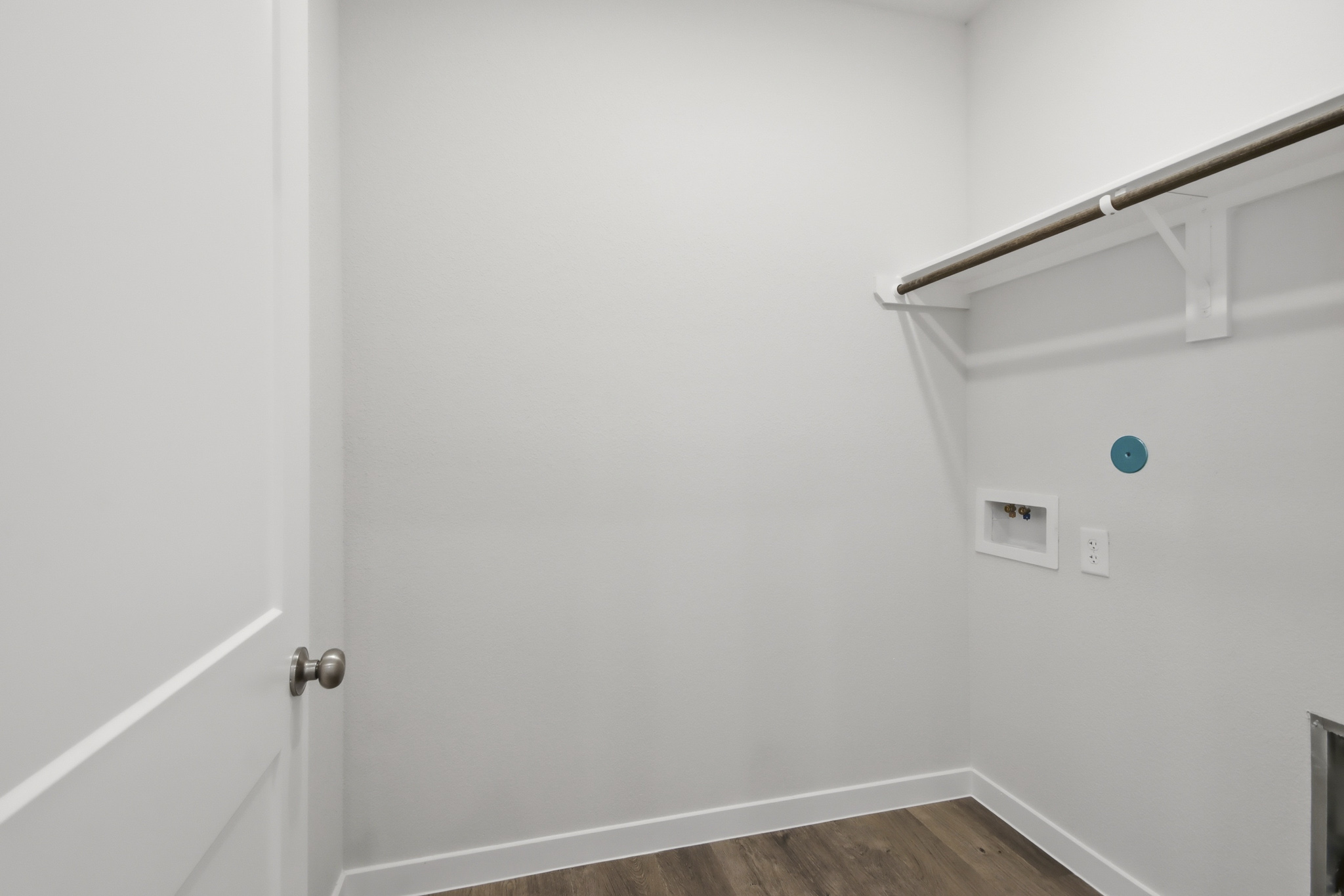 A white door with a metal bar.