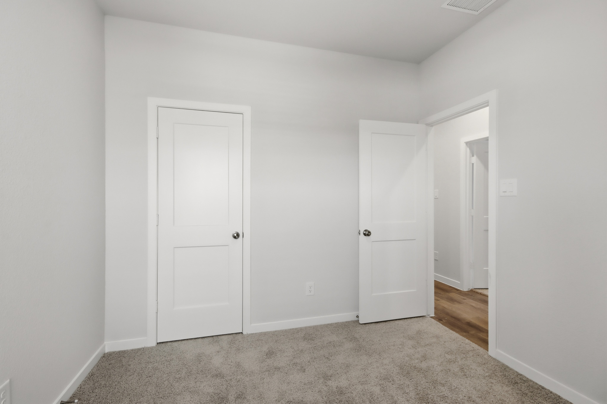 A hallway with white doors.