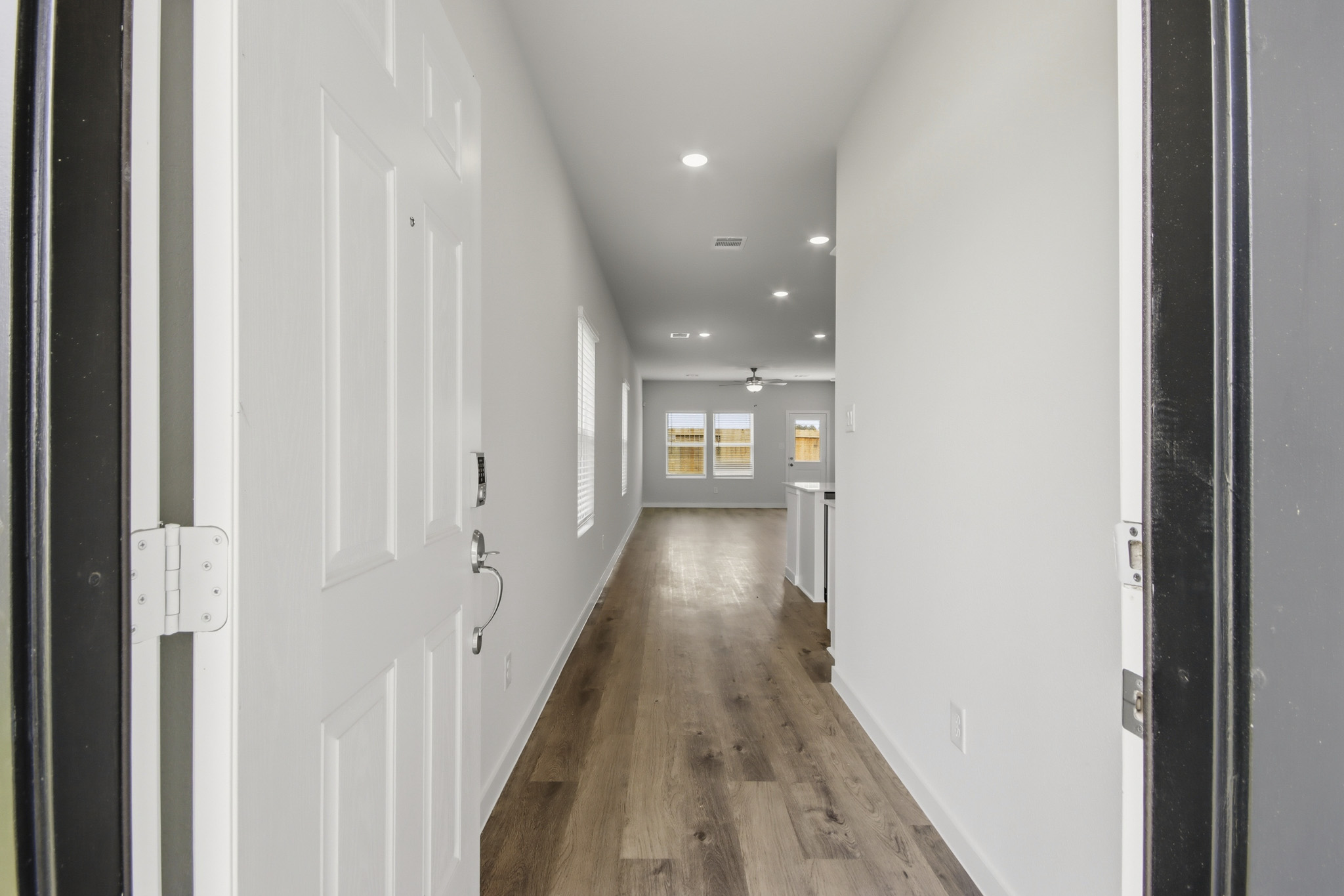 A hallway with white doors.