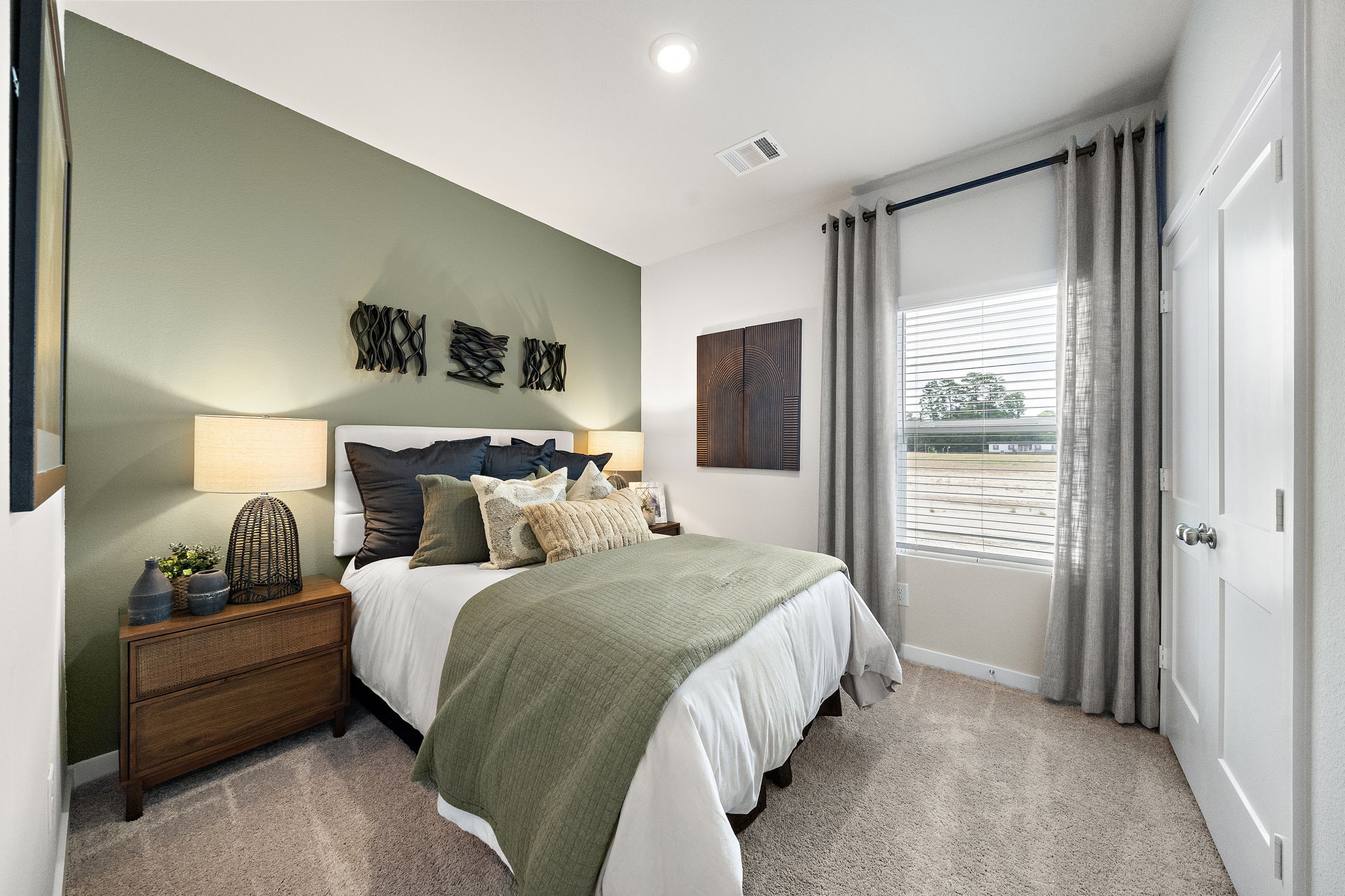 A bedroom with a large window.