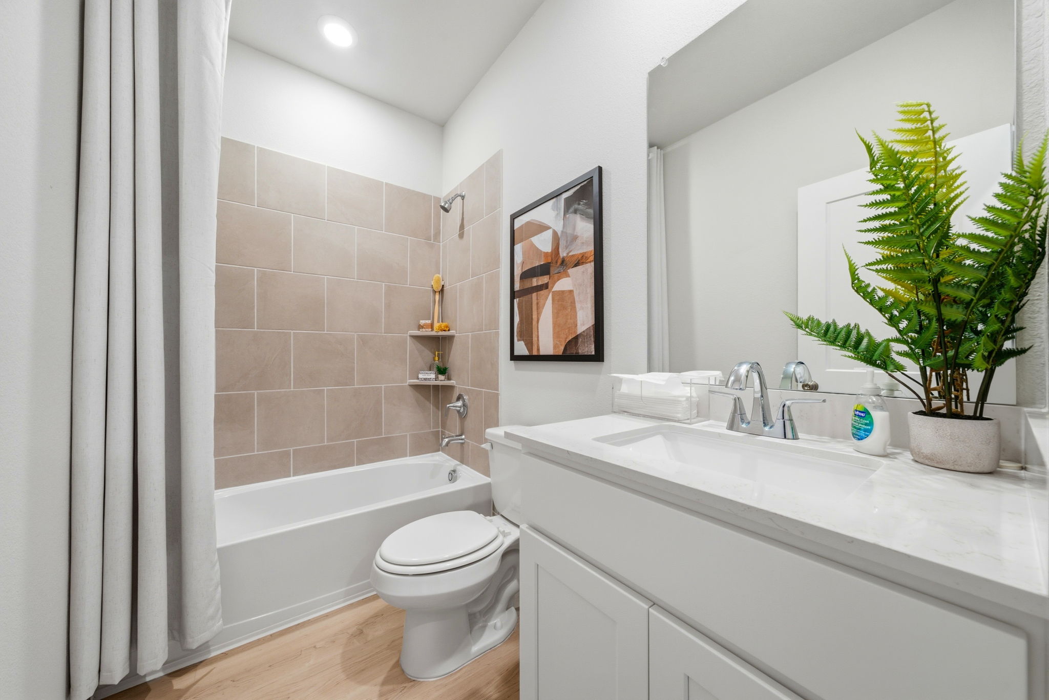 A bathroom with a tub sink and toilet.