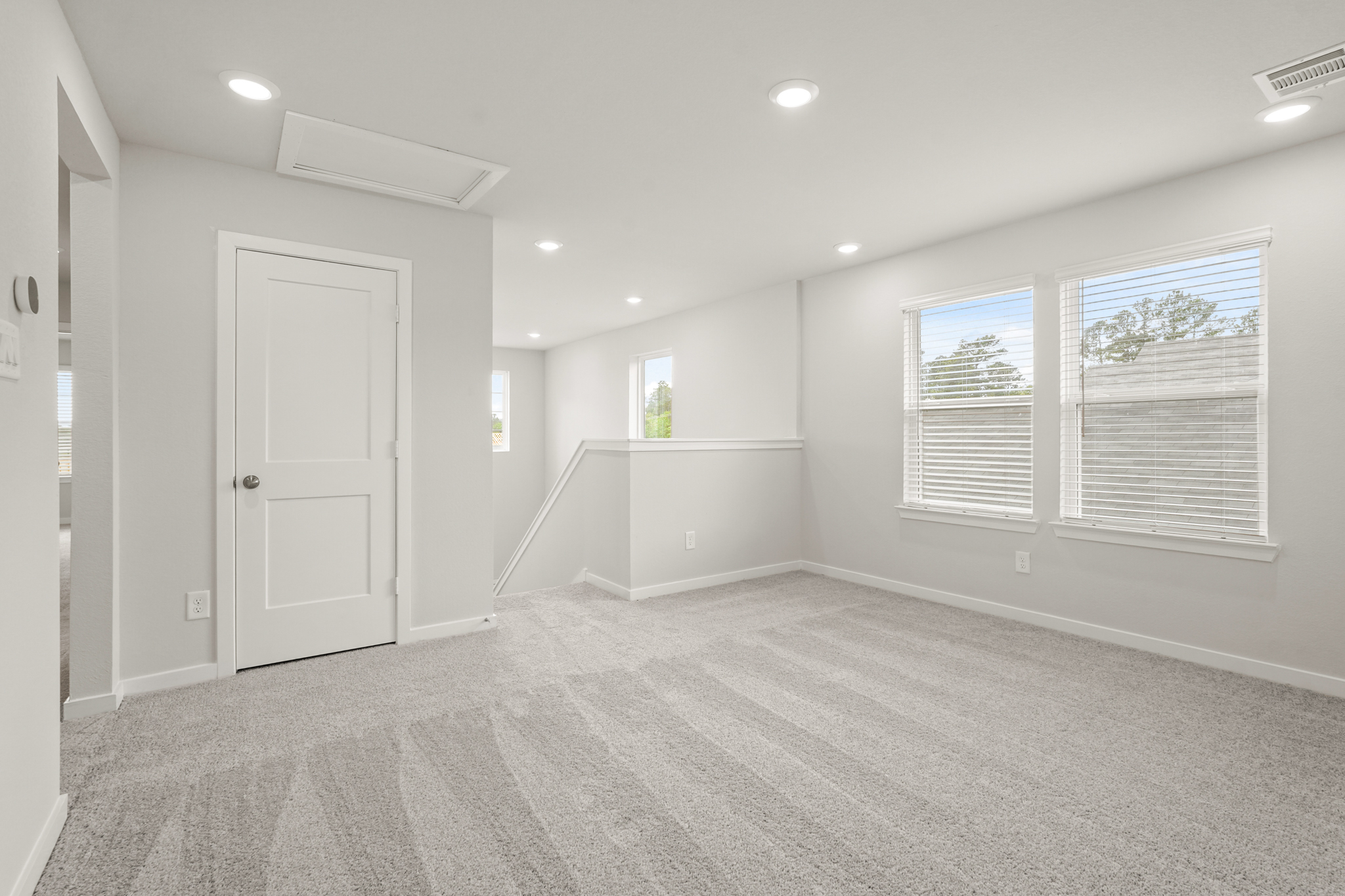 A room with white walls and a white door.