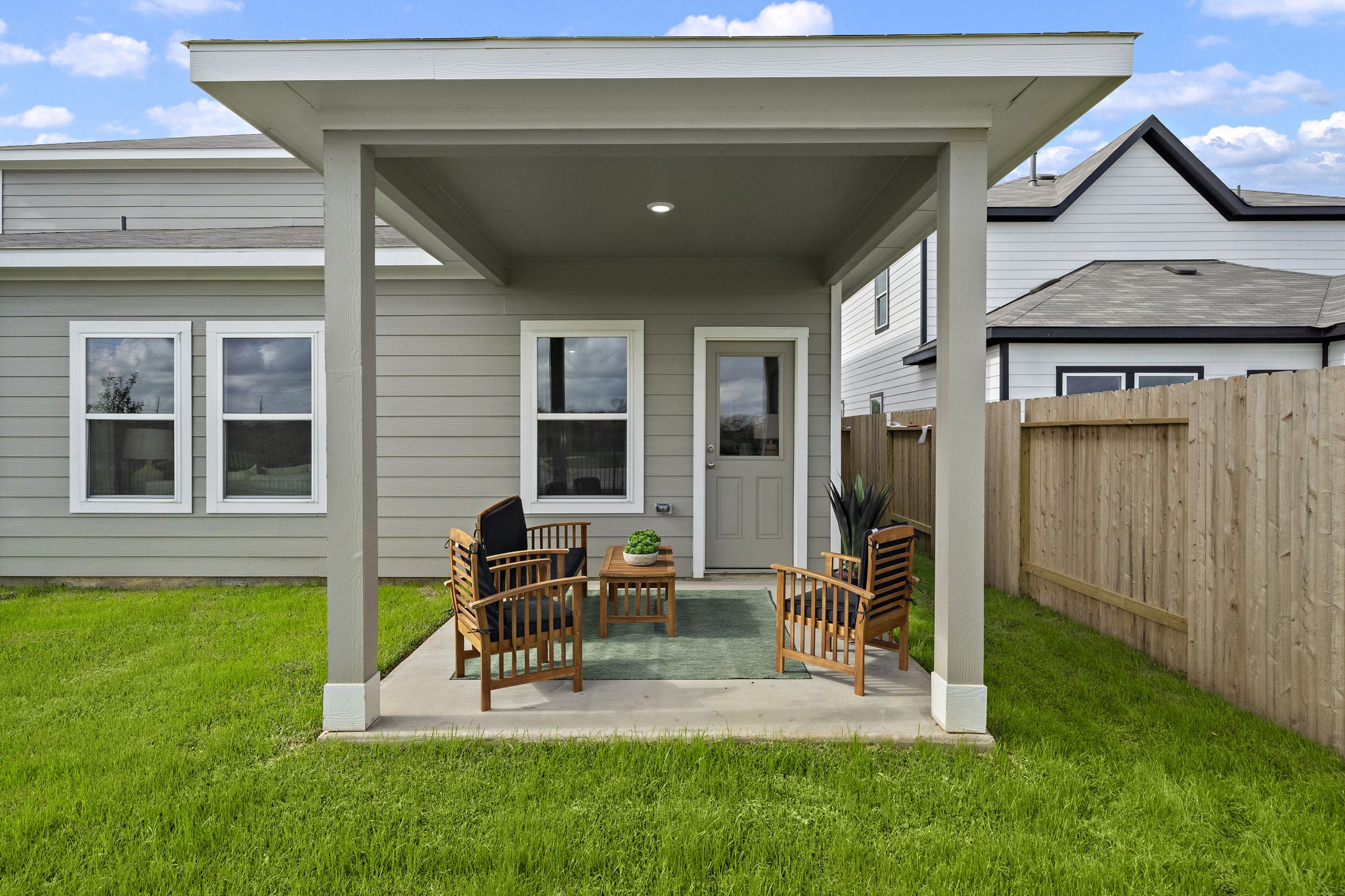 A house with a deck and chairs.