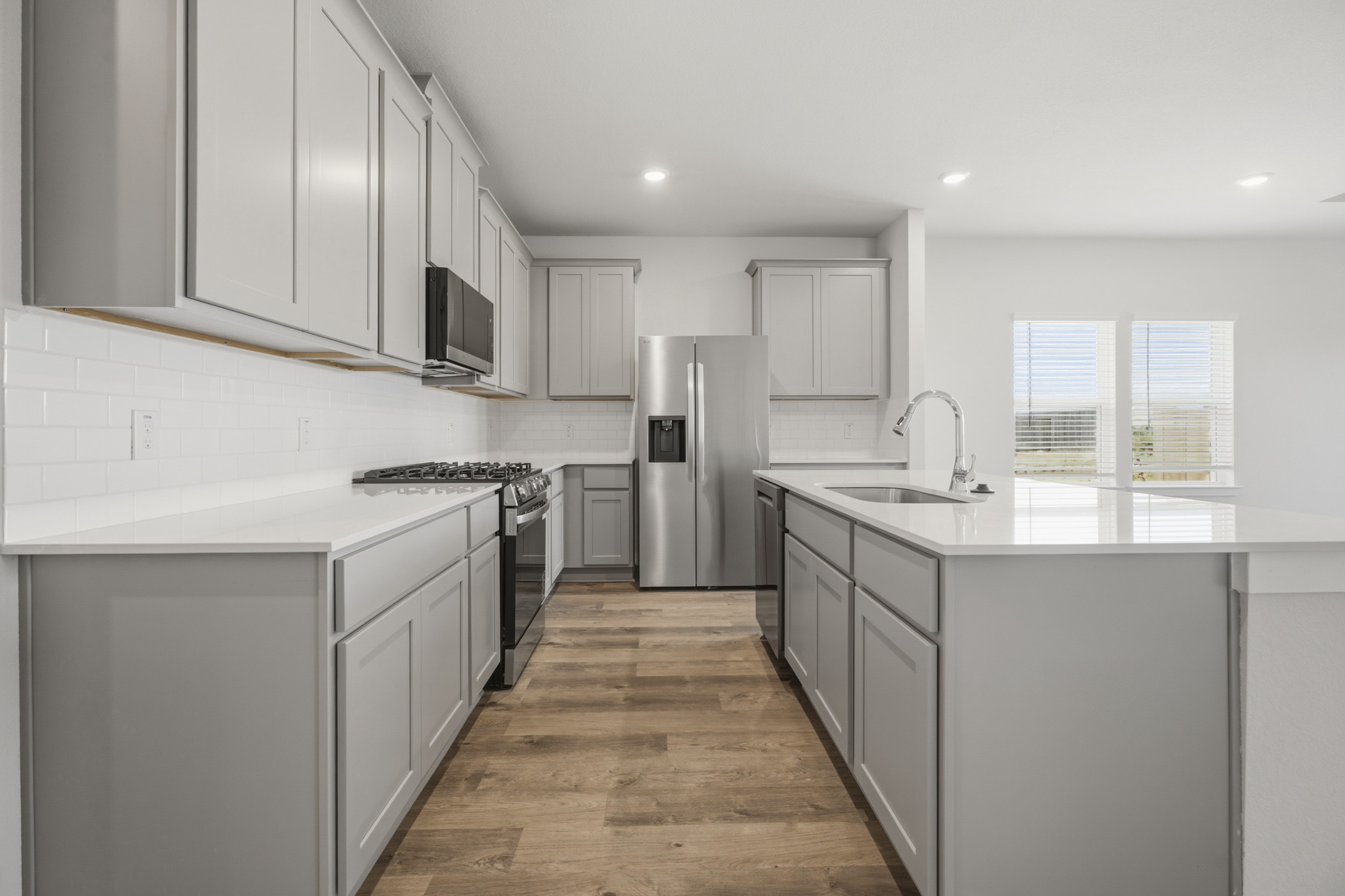 A kitchen with white cabinets.