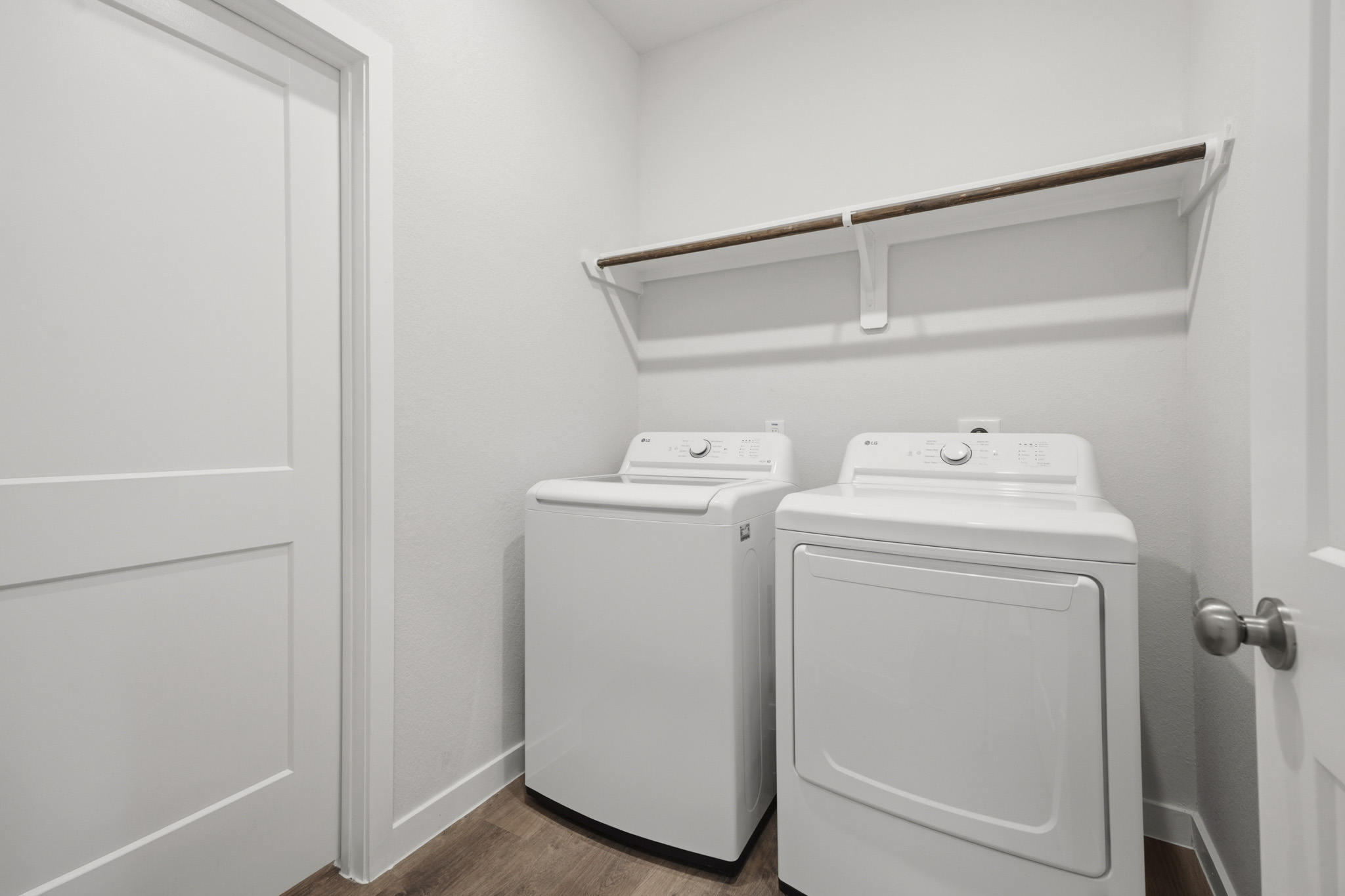A white washing machine and a white door.