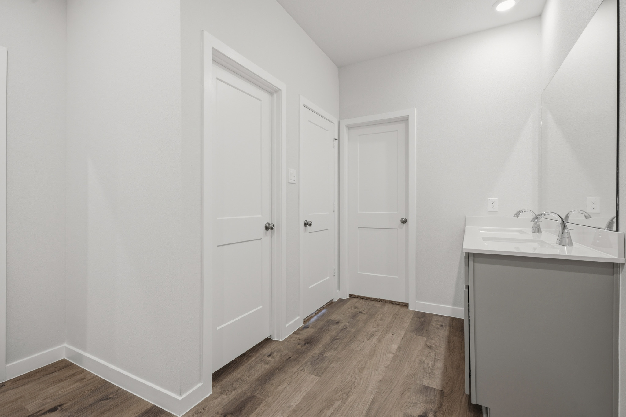 A bathroom with white doors.