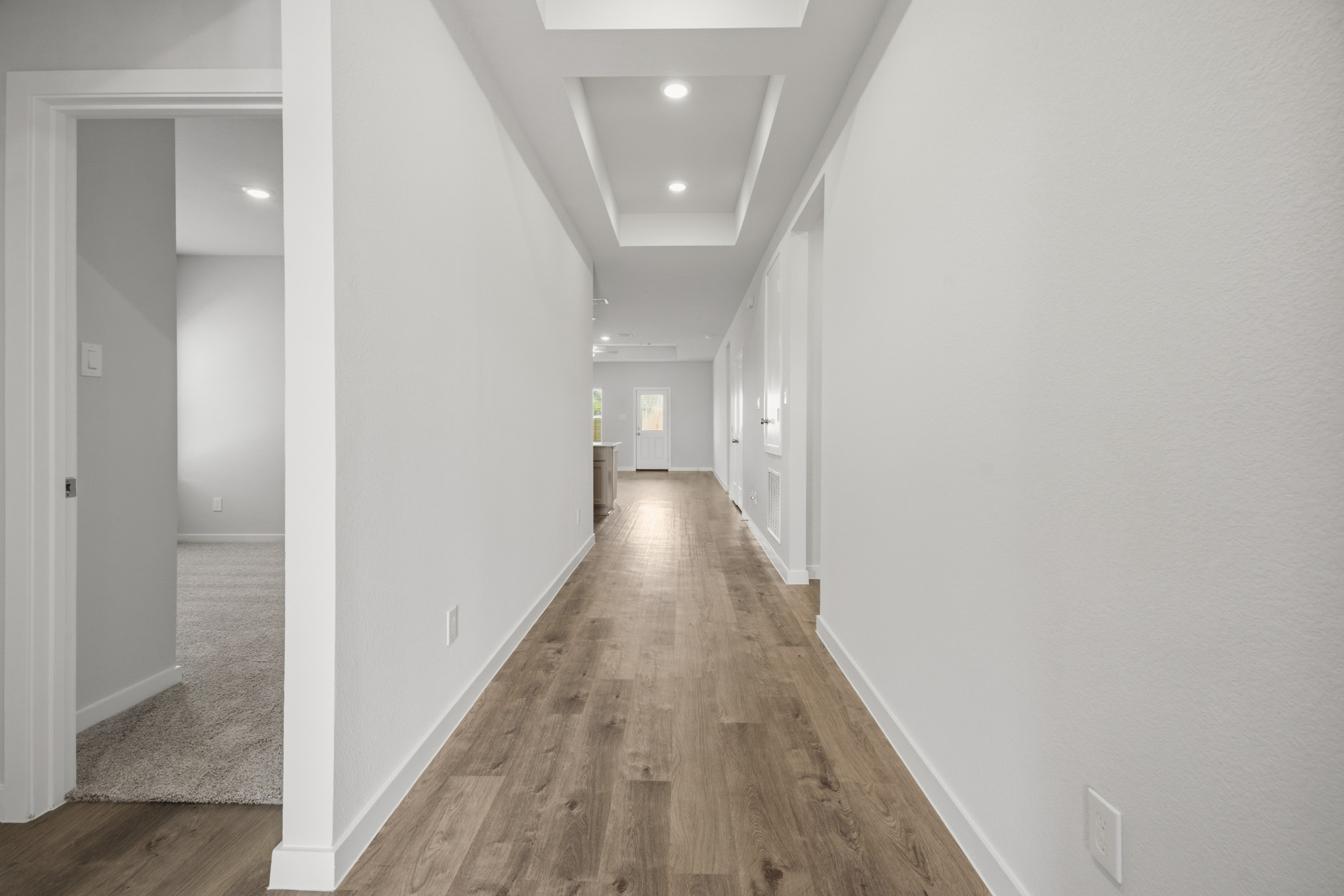 A long hallway with white walls.