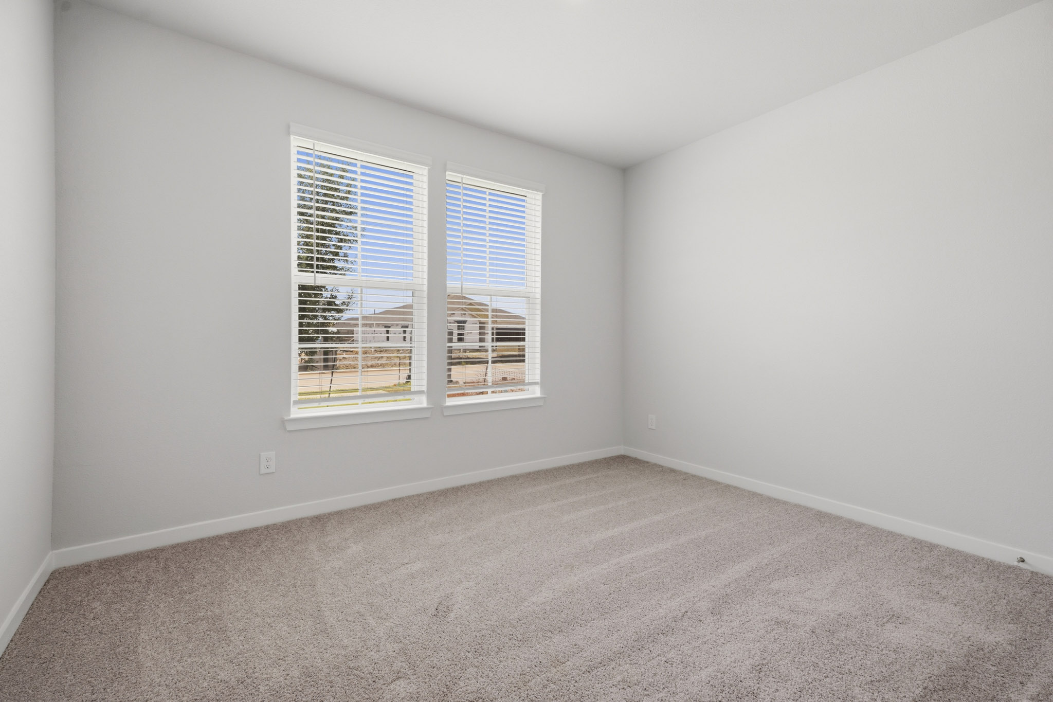 A room with a window and a carpet.