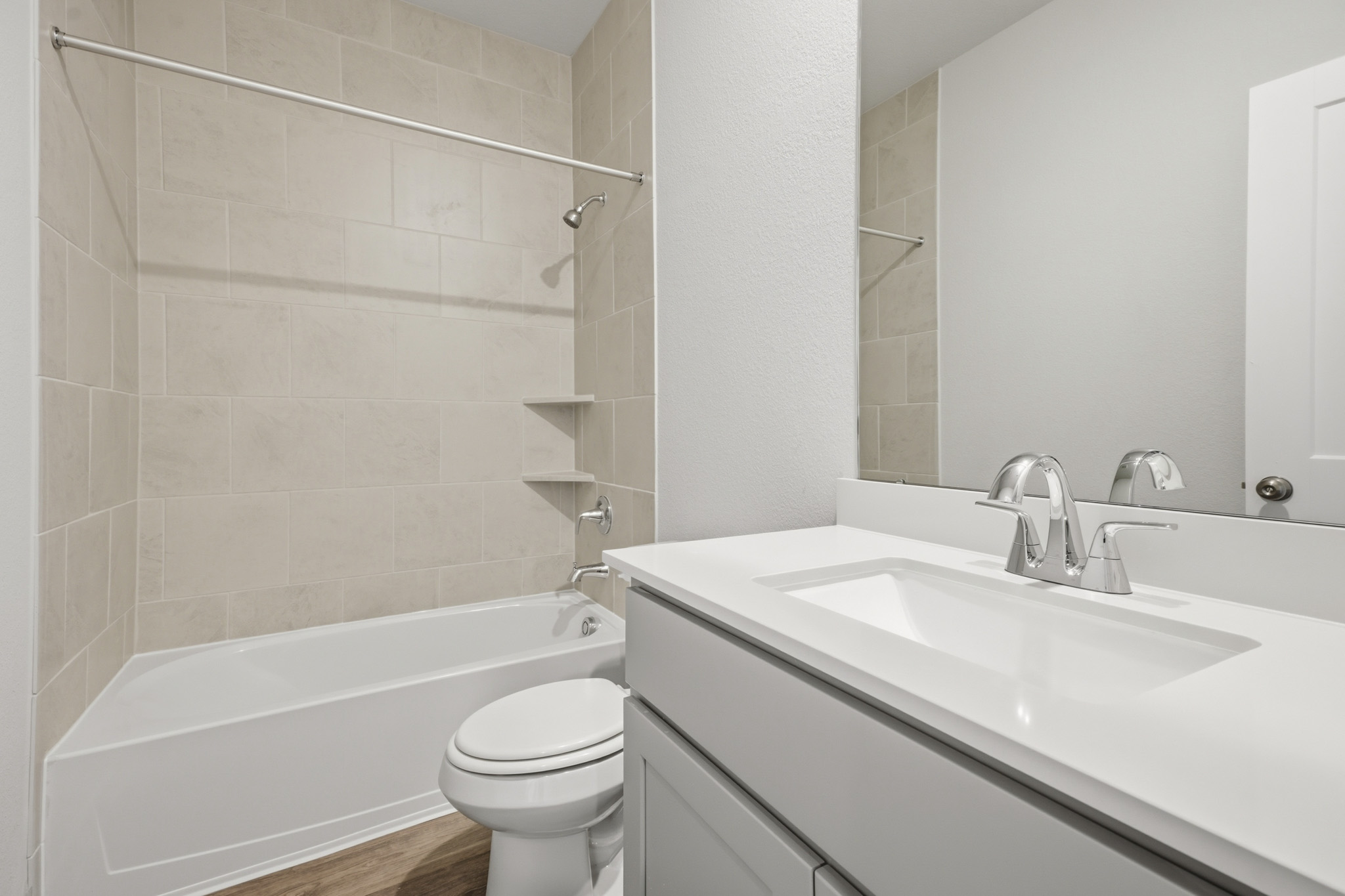 A bathroom with a sink toilet and bathtub.