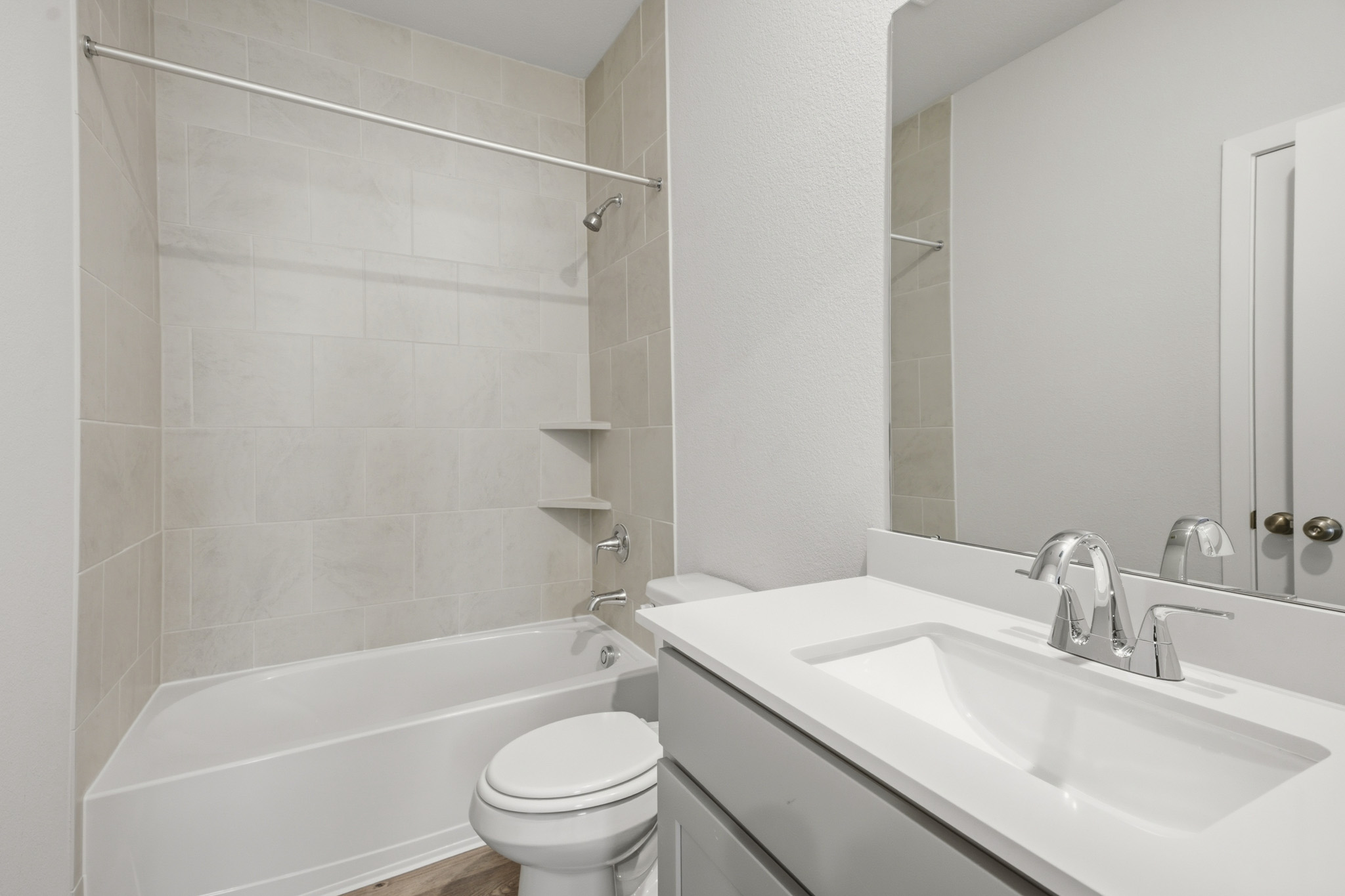 A bathroom with a tub sink and toilet.