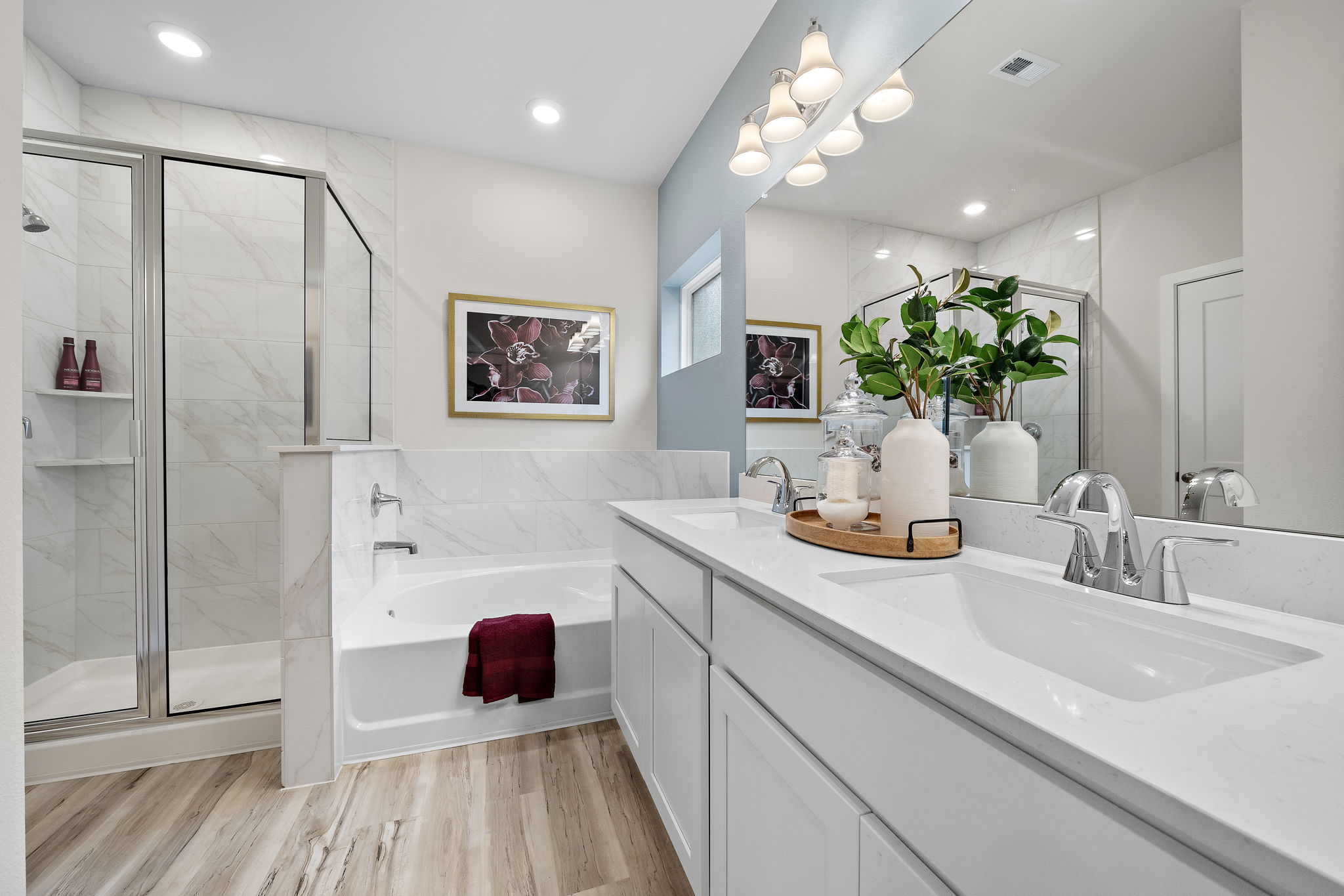 A bathroom with a tub sink and a shower.