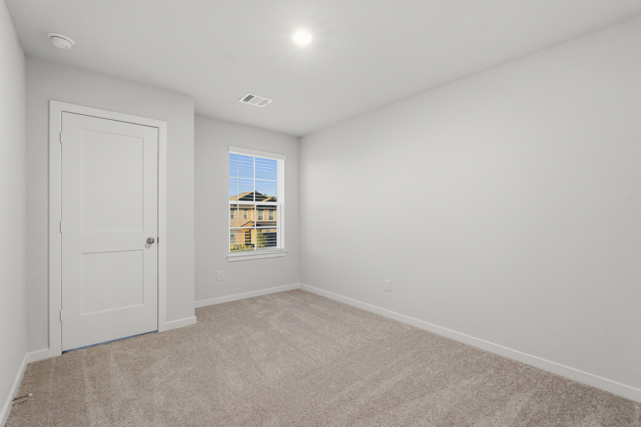 A room with a window and a door.