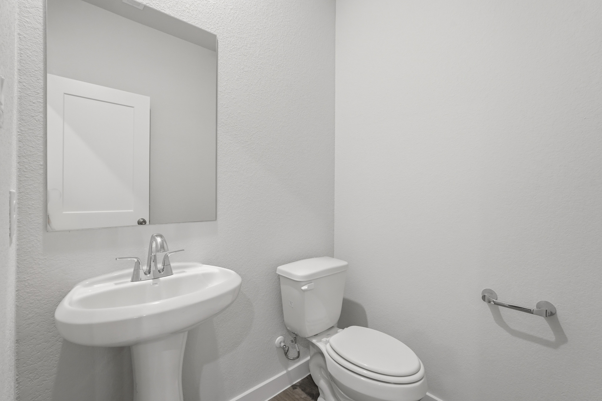 A bathroom with a toilet and sink.