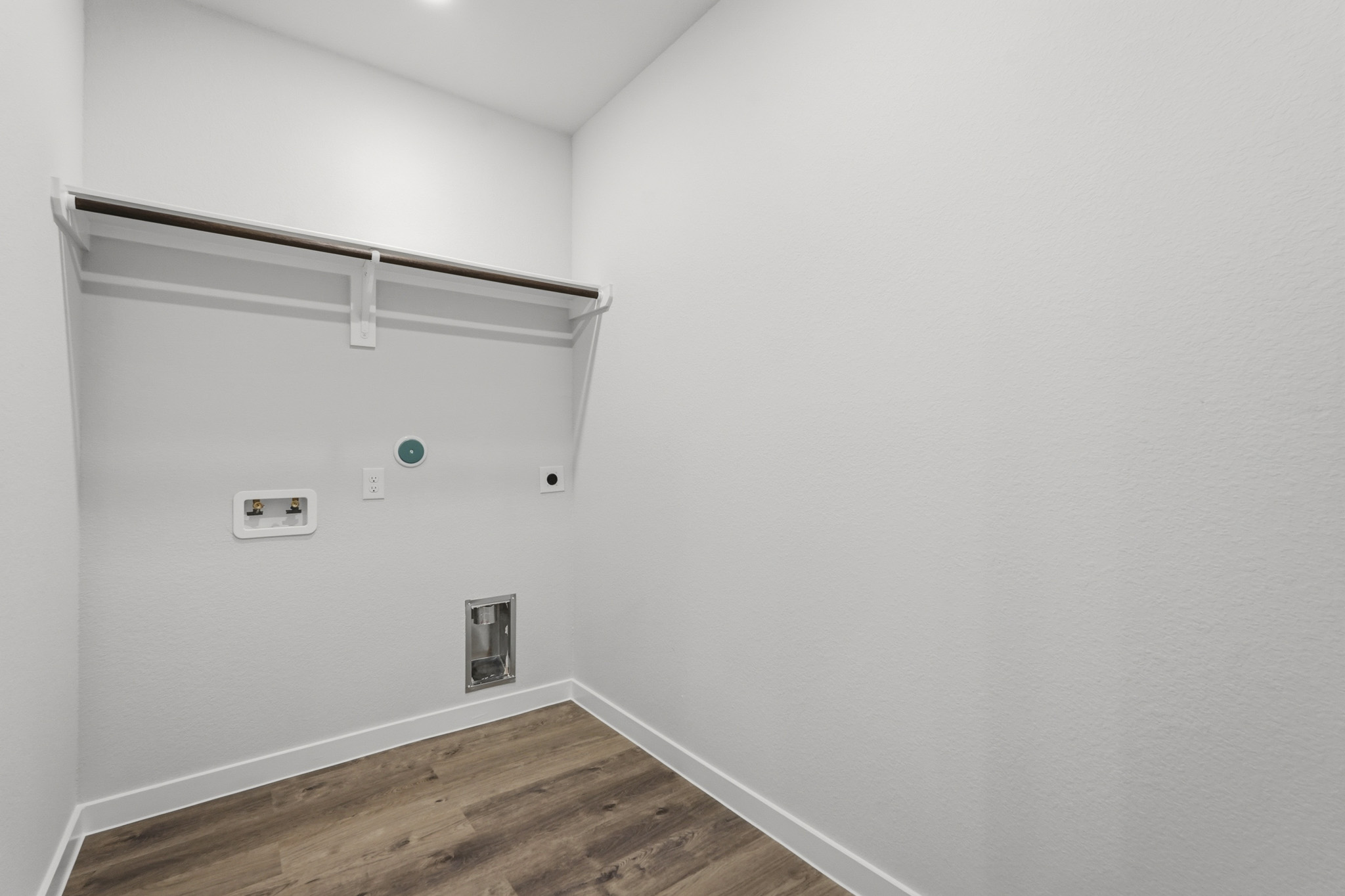 A white wall with a light on it.