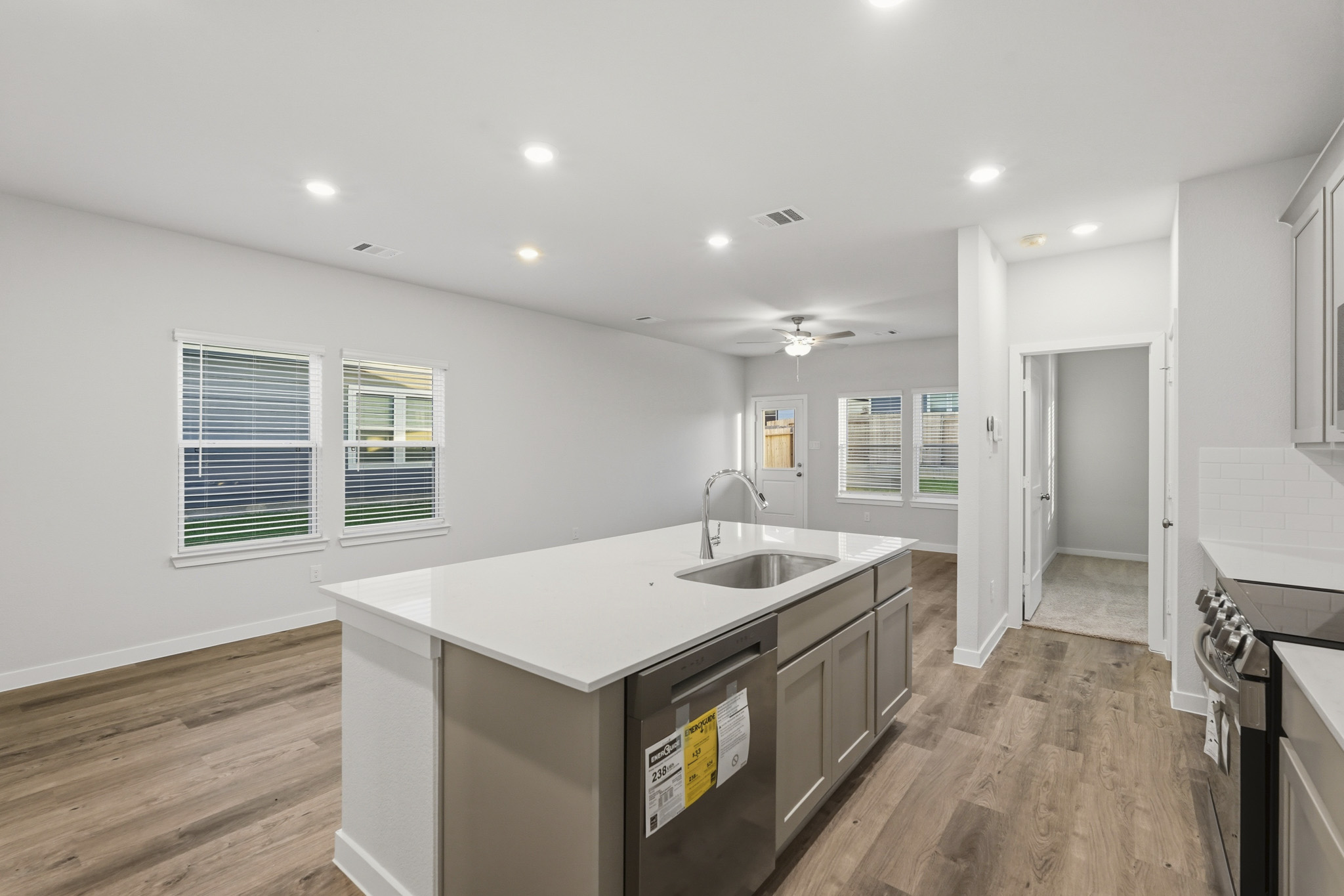 A kitchen with white cabinets.