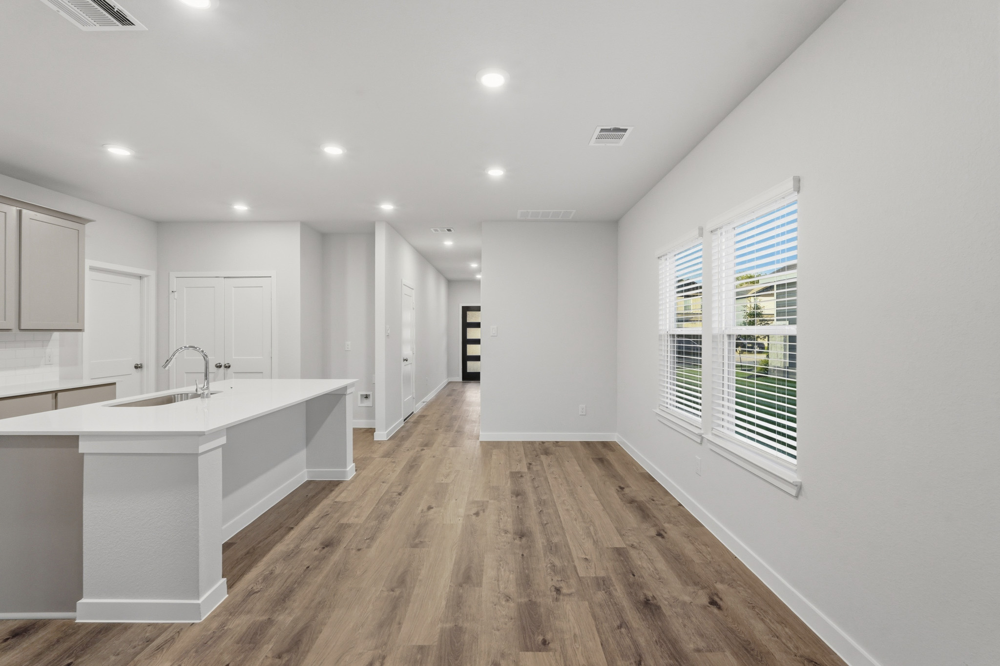 A kitchen with white cabinets.