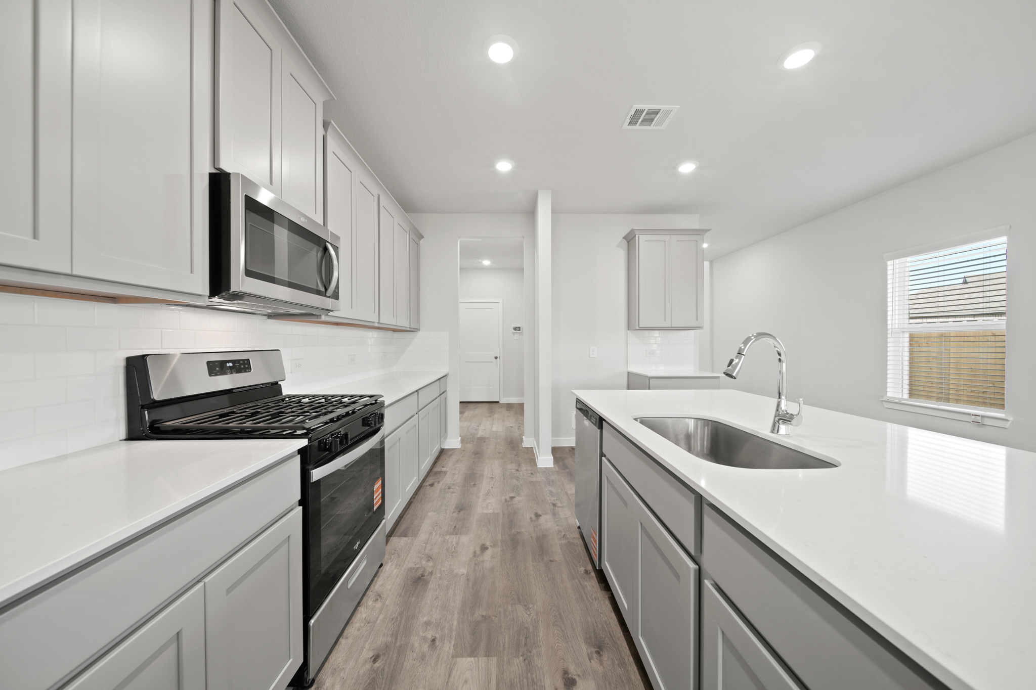 A kitchen with white cabinets.