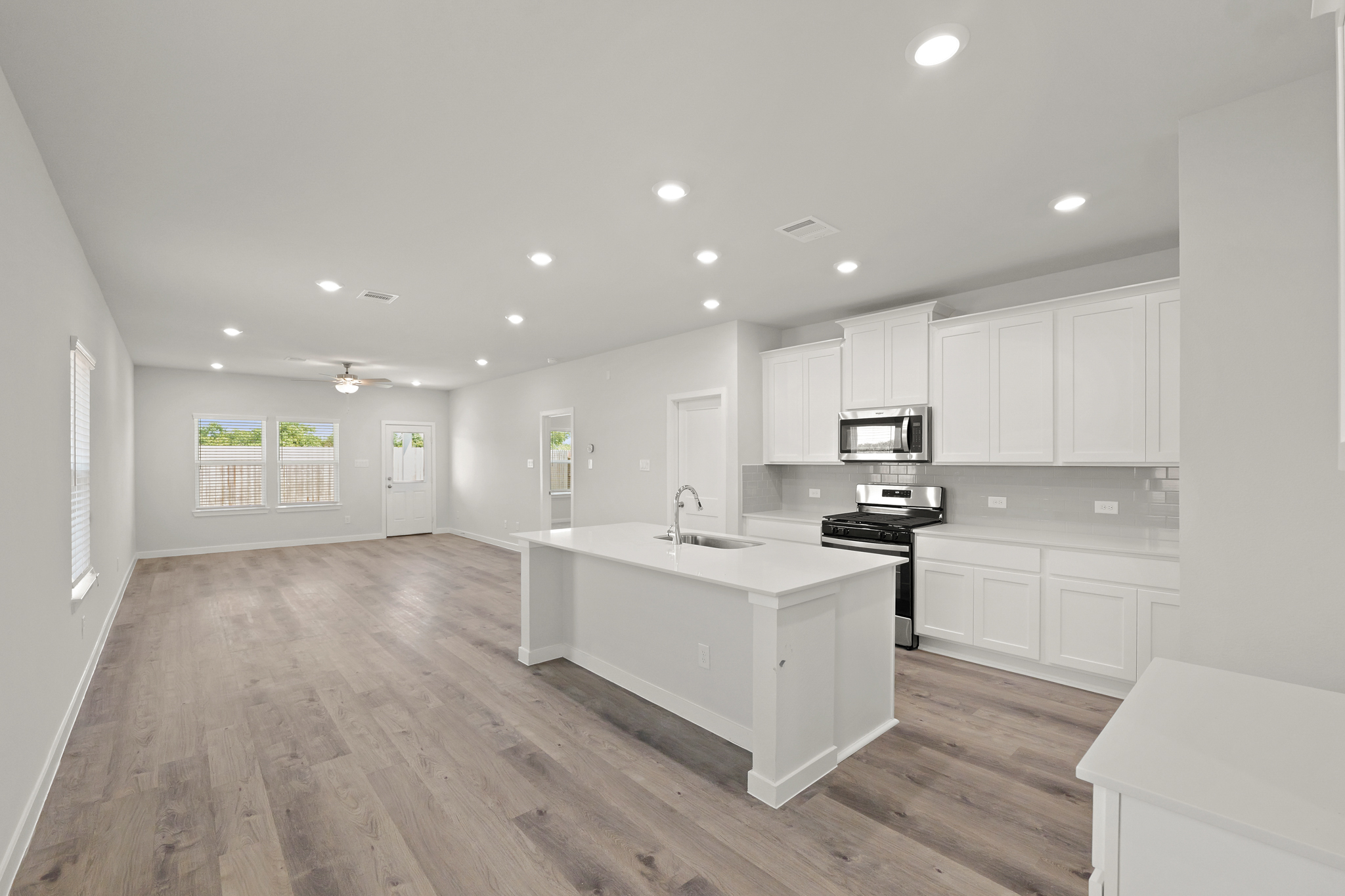 A kitchen with white cabinets.