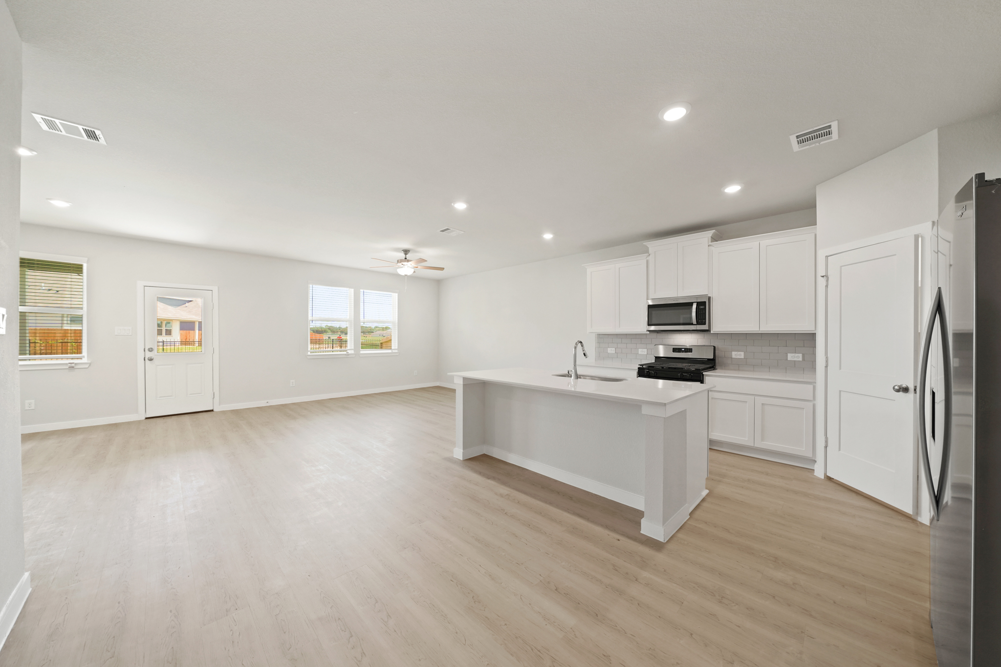 A kitchen with white cabinets.