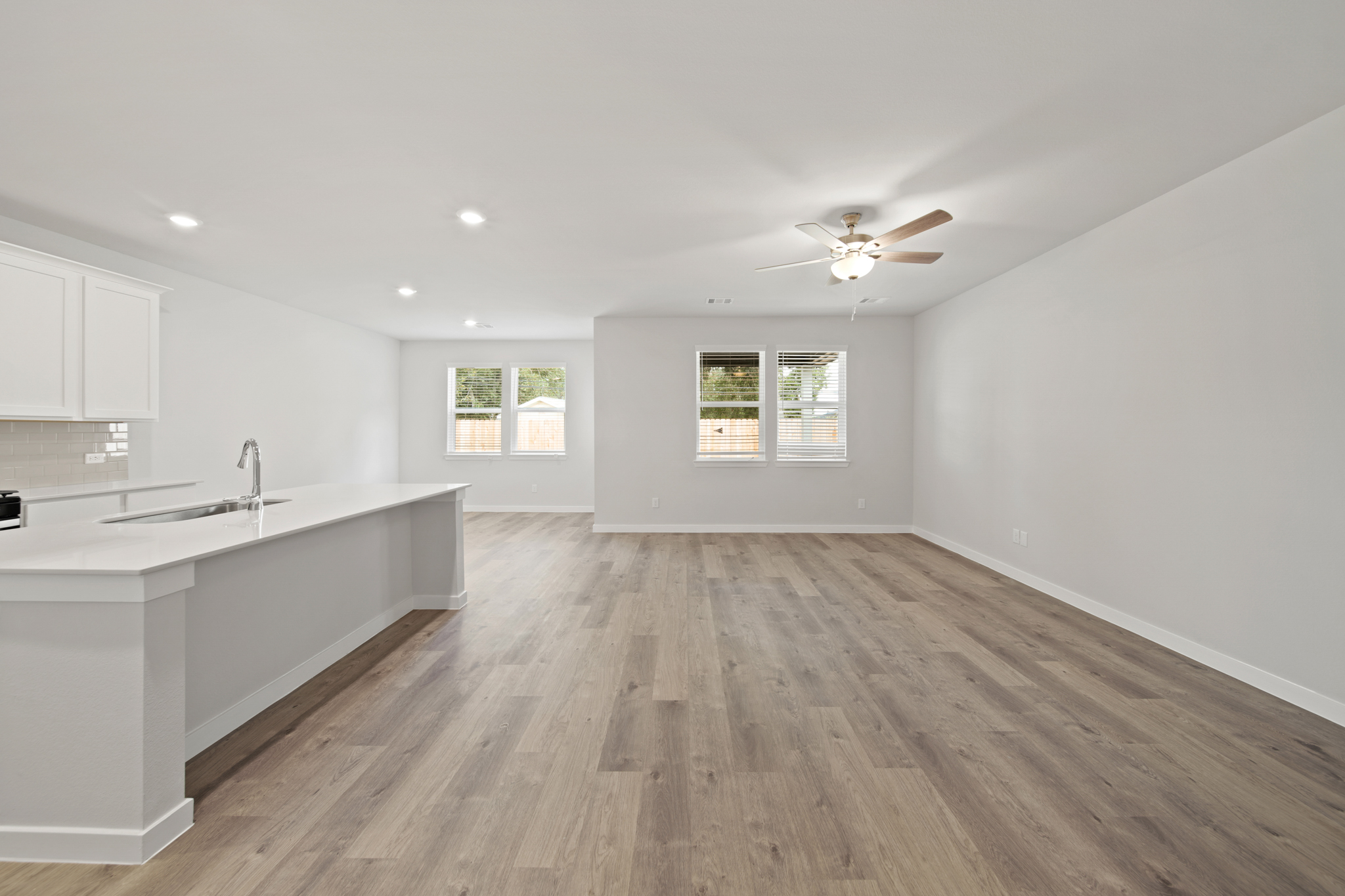 A kitchen with a wood floor.