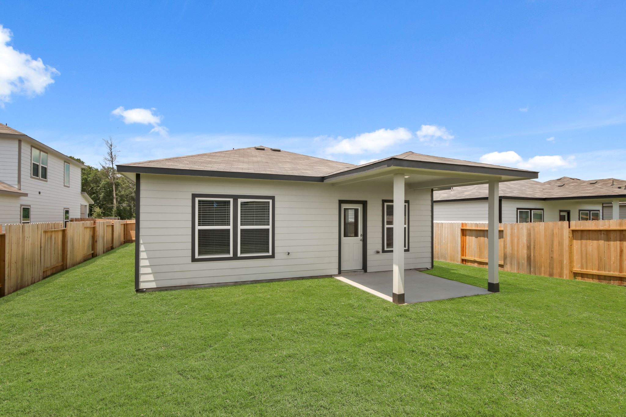 A house with a fence and grass.
