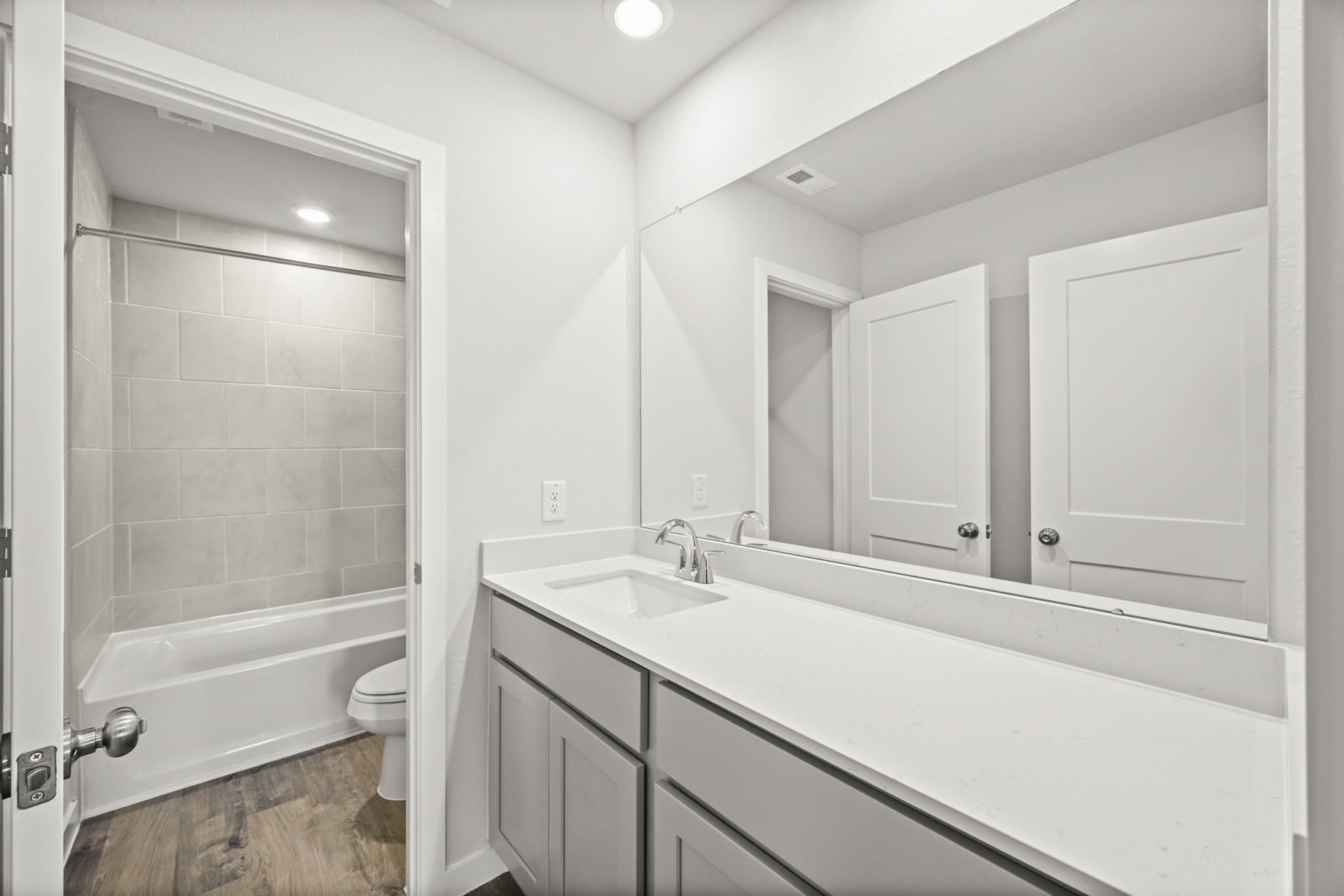 A bathroom with a tub sink and toilet.