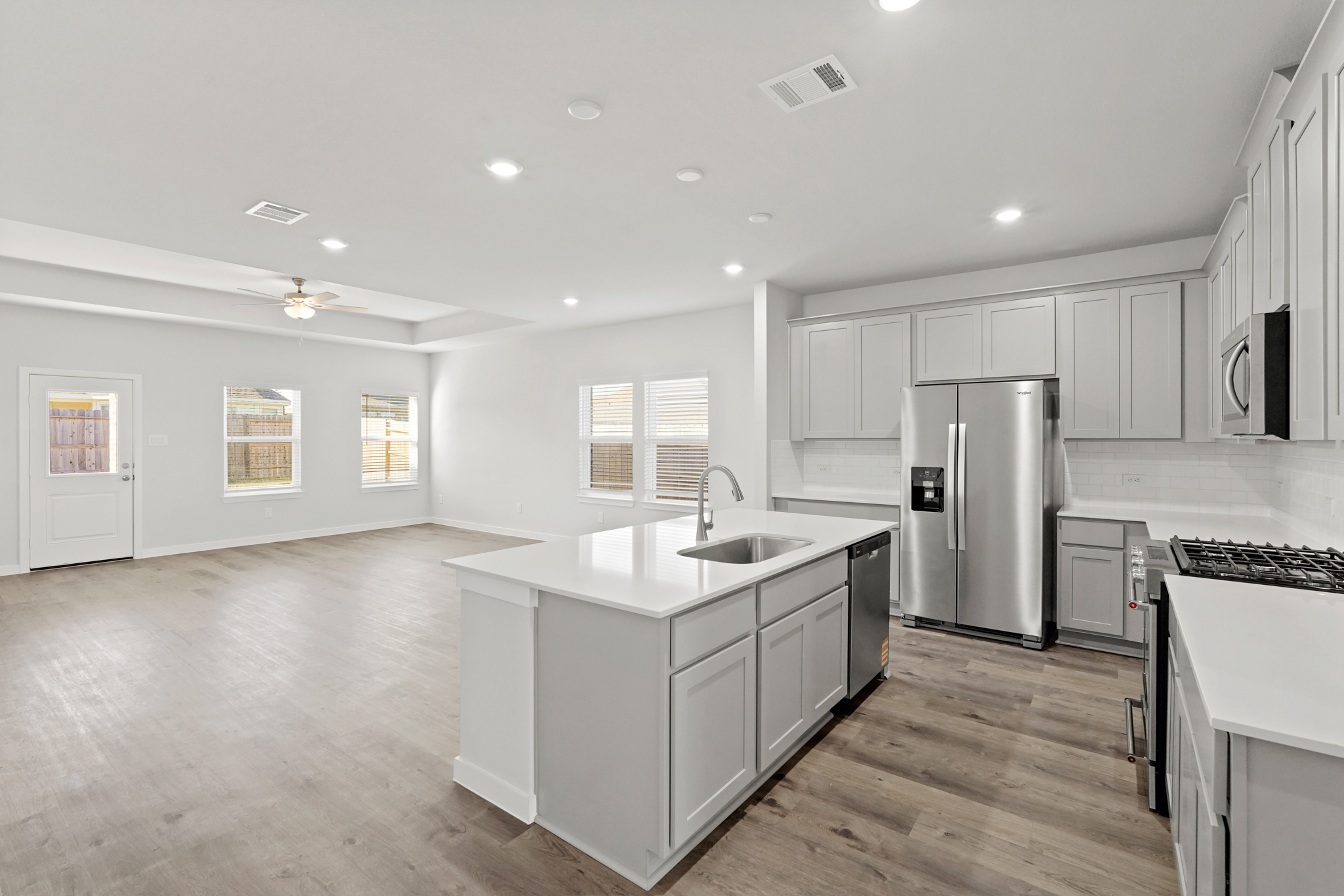 A kitchen with white cabinets.