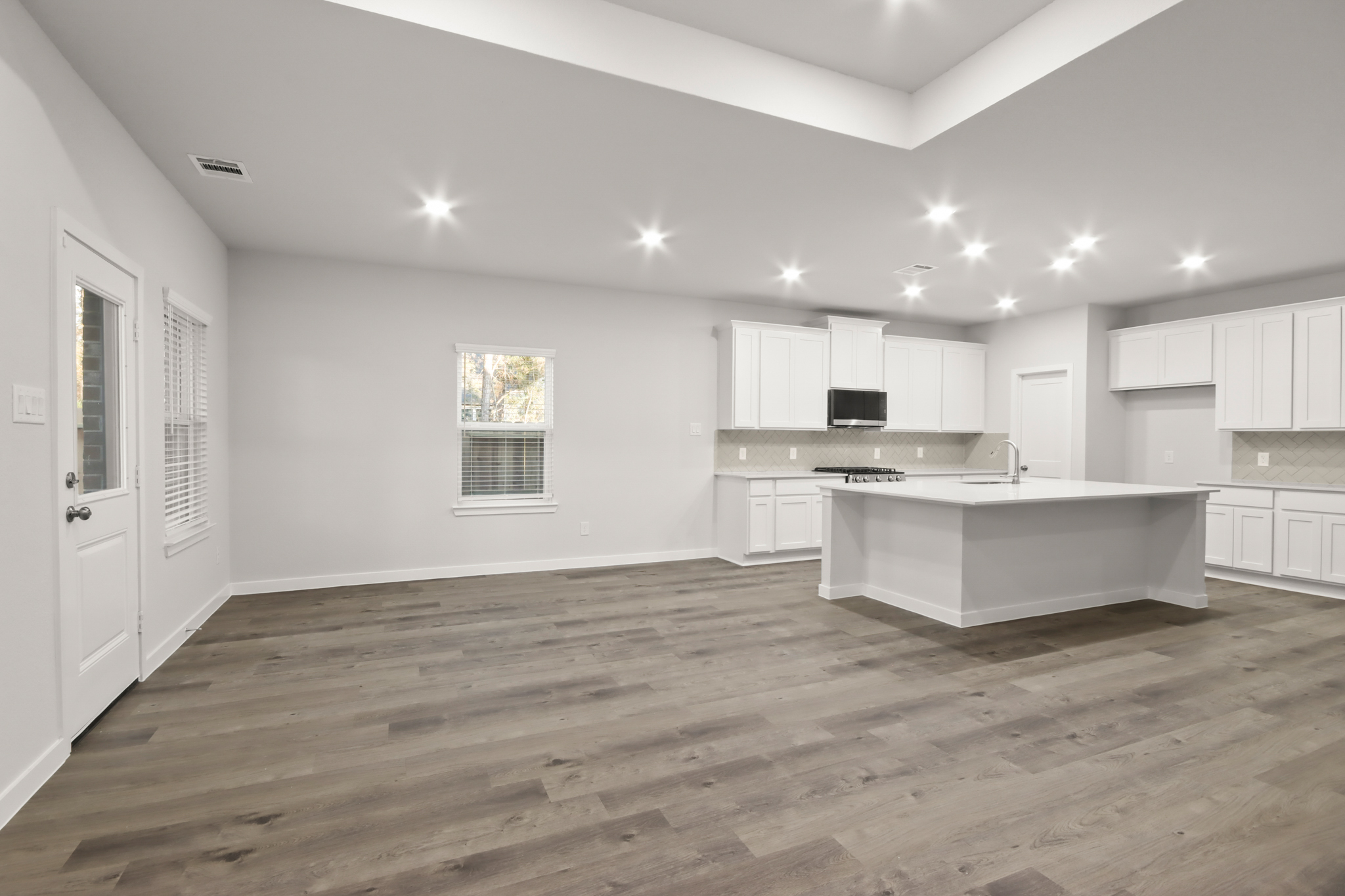 A kitchen with white cabinets.