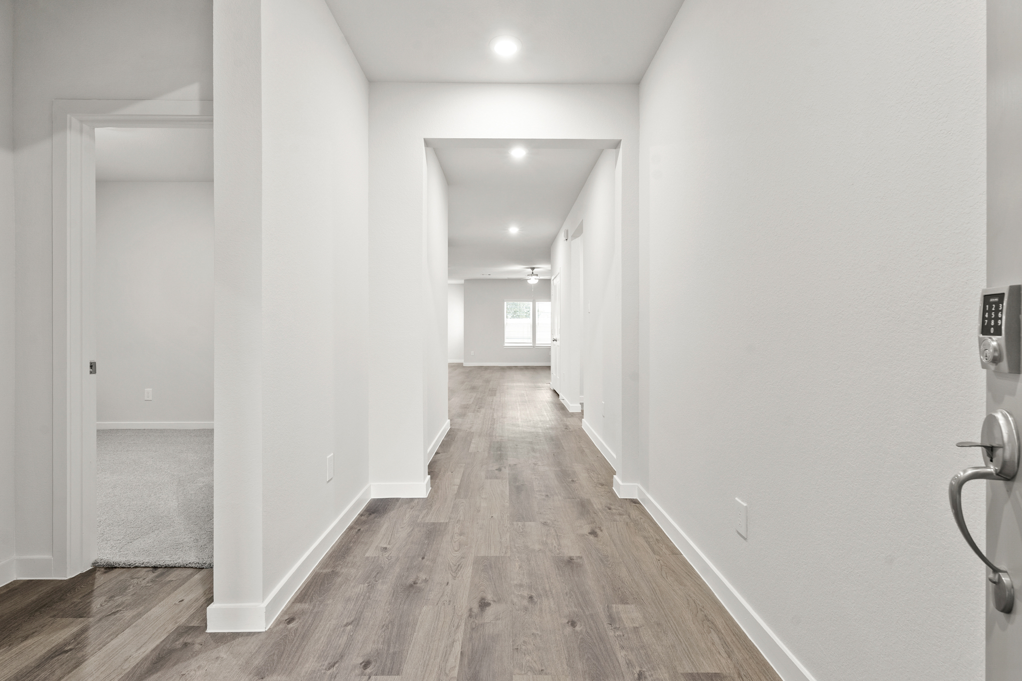 A hallway with white walls.