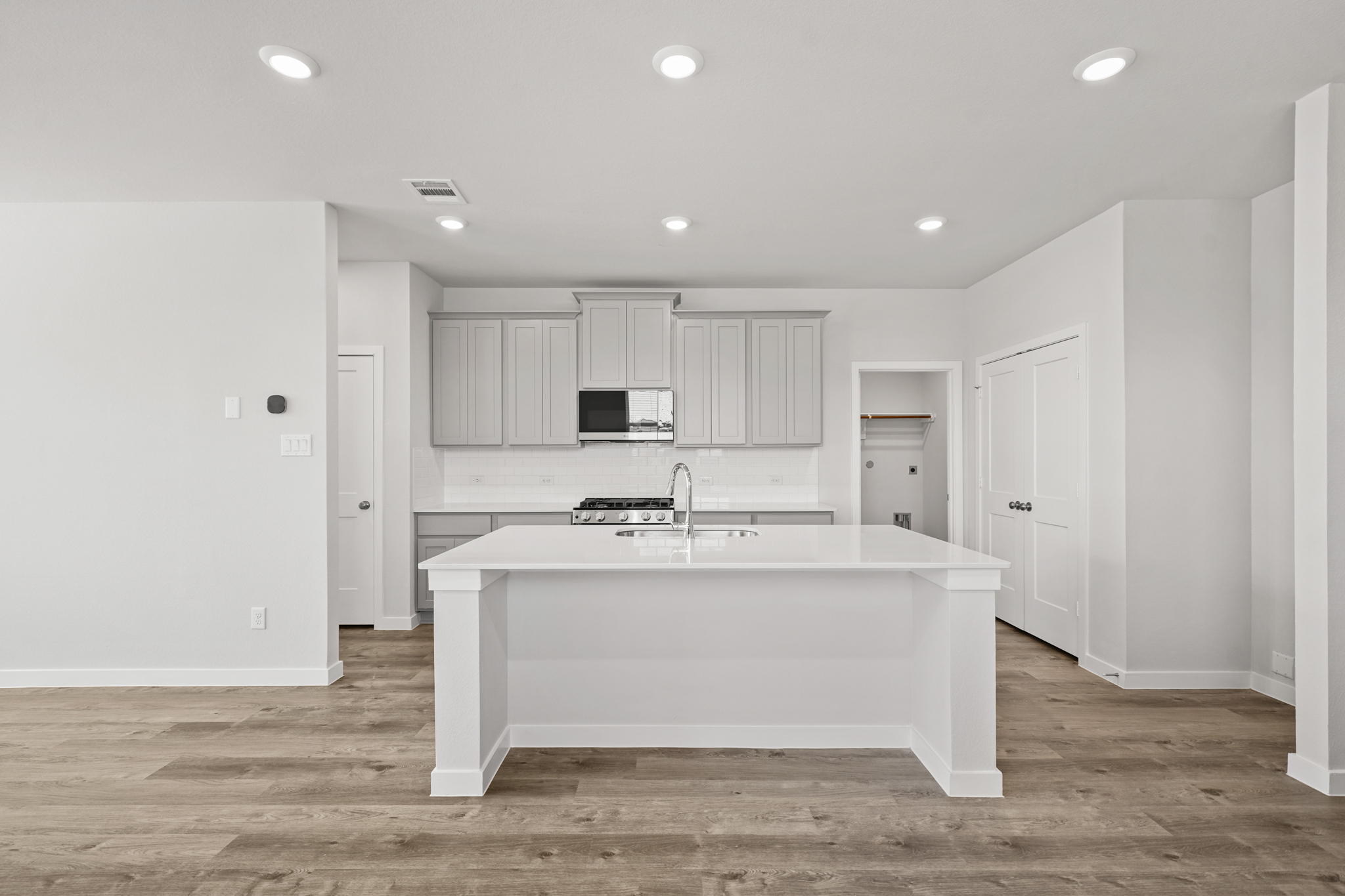 A large white kitchen with white cabinets.