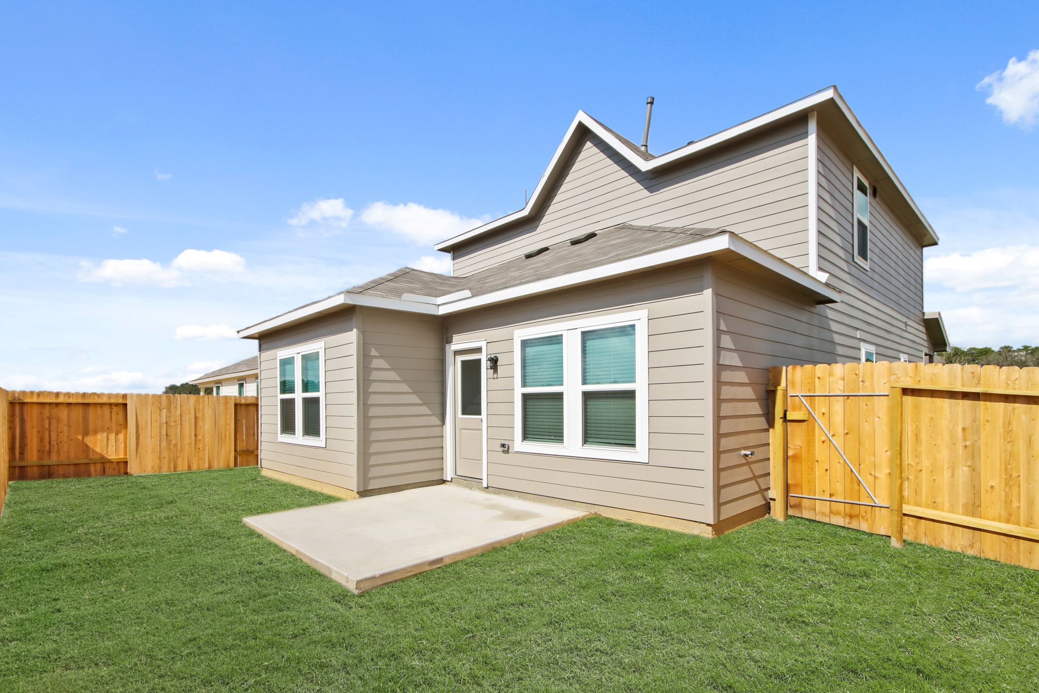 A house with a fence and a yard.