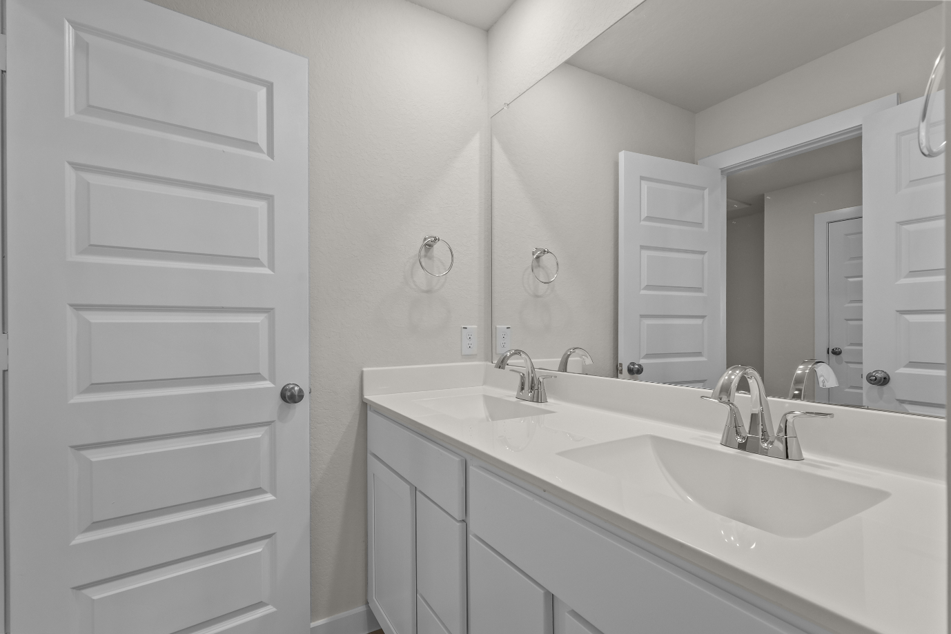 A bathroom with a large mirror.