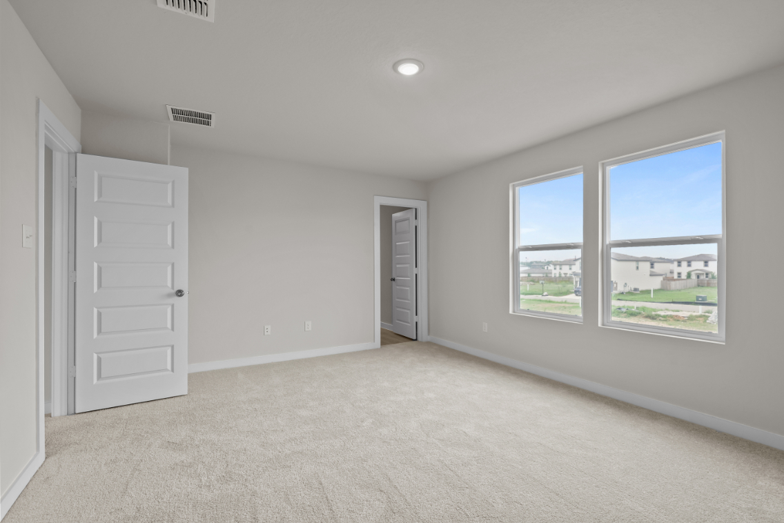 A room with white walls and a window.