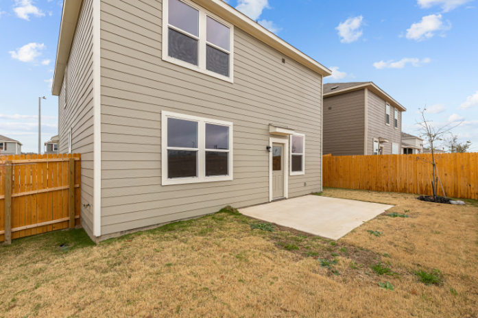 A house with a fence and a yard.