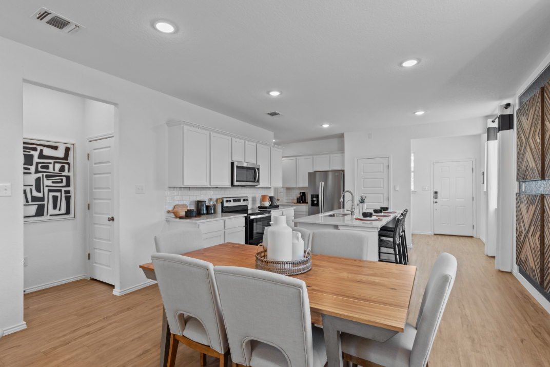 A kitchen with white cabinets.