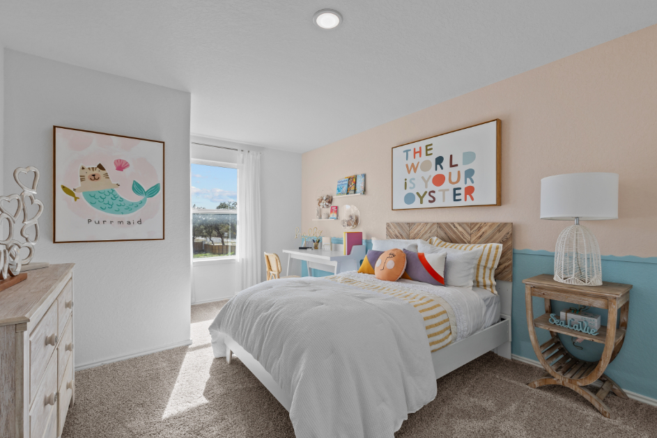 A bedroom with a bed and a lamp.