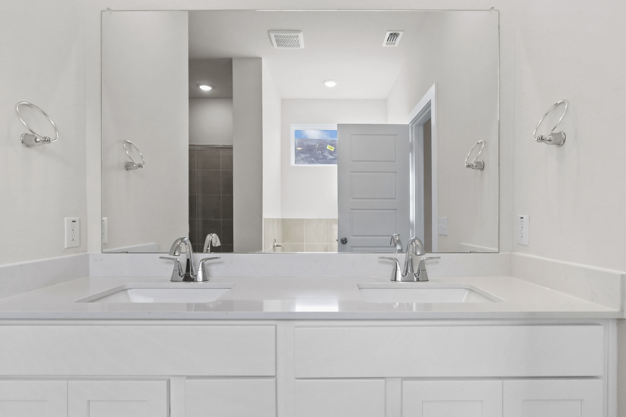 A bathroom with a large mirror.