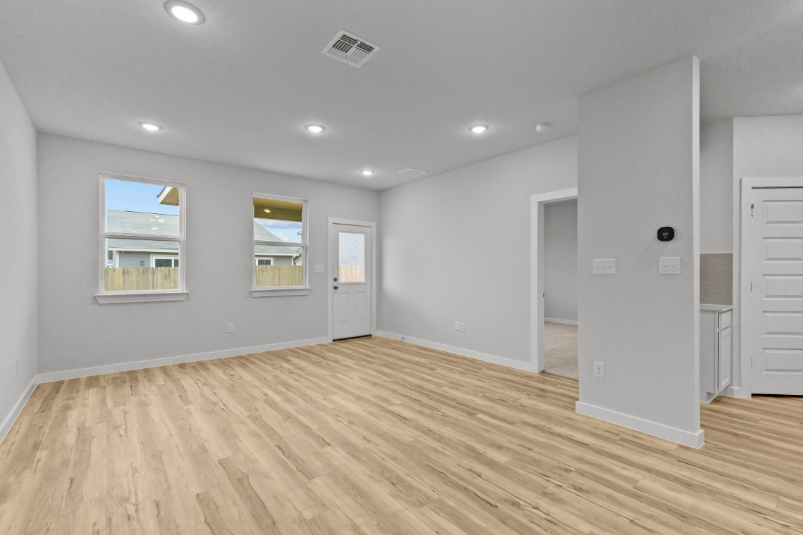 A room with white walls and a wood floor.