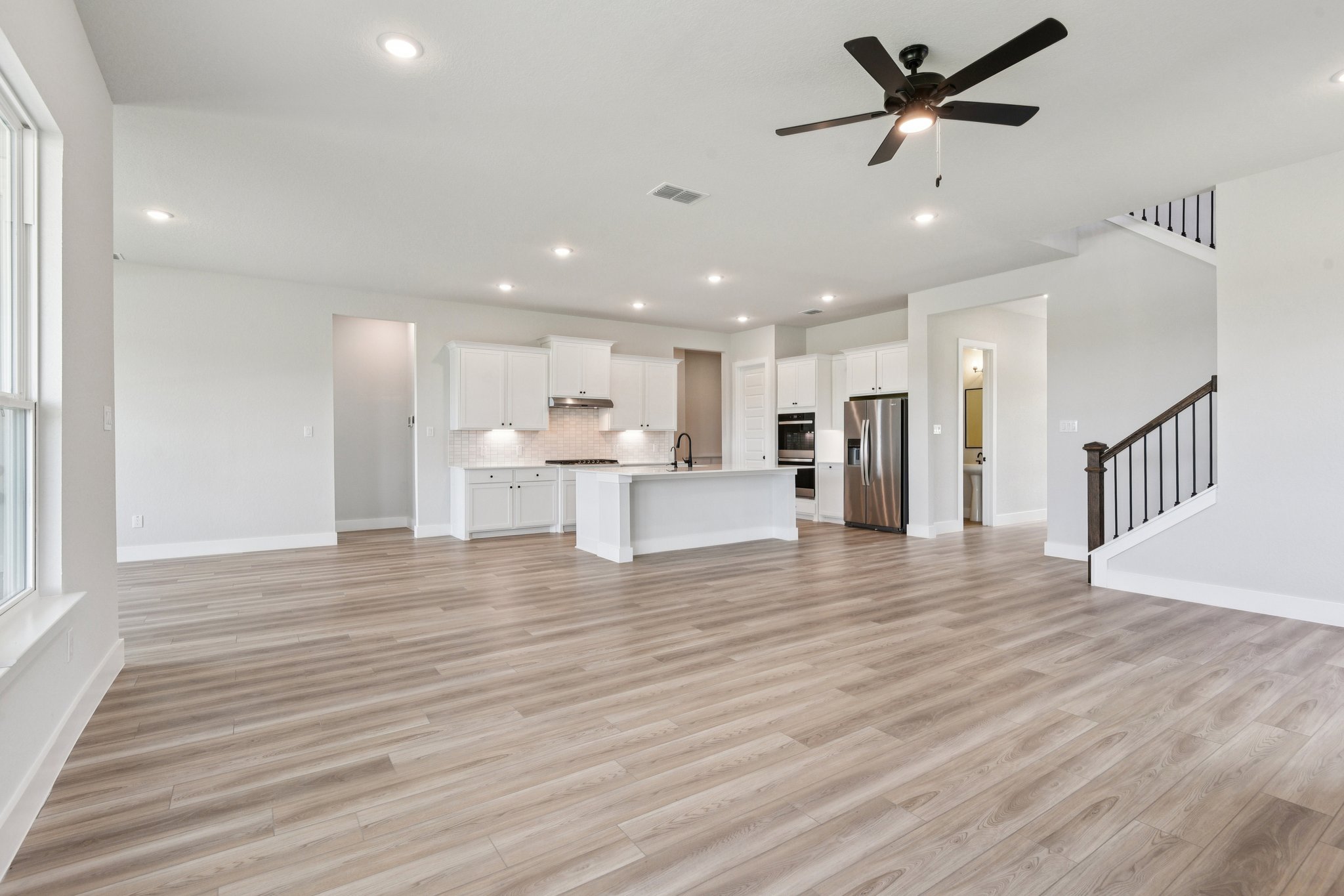 A large kitchen with white cabinets.