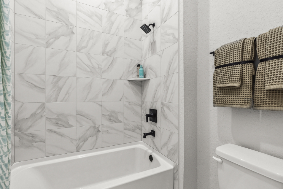 A bathroom with a shower and toilet.