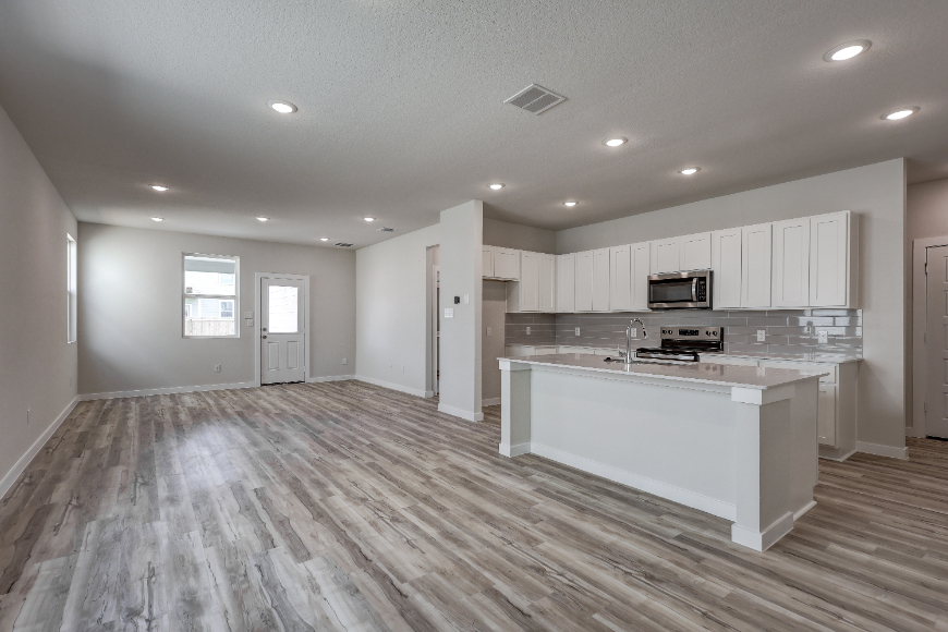 A kitchen with white cabinets.