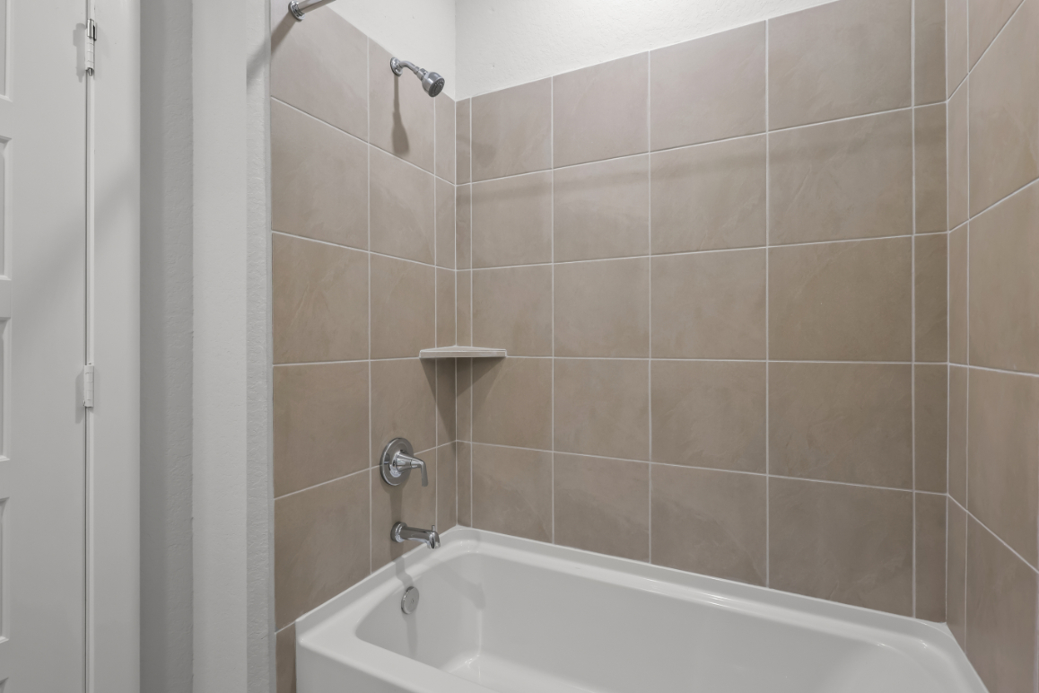 A bathtub in a bathroom.