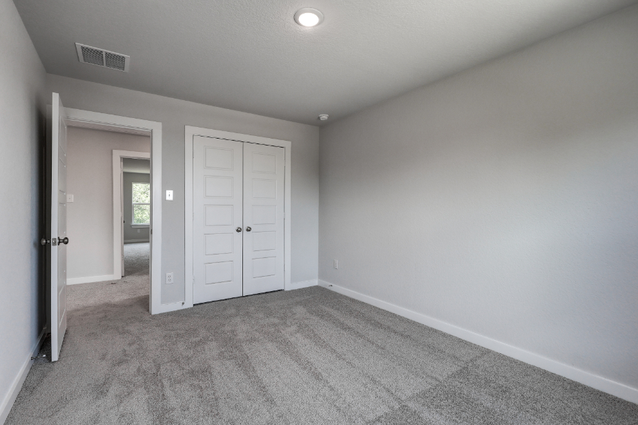 A hallway with white doors.