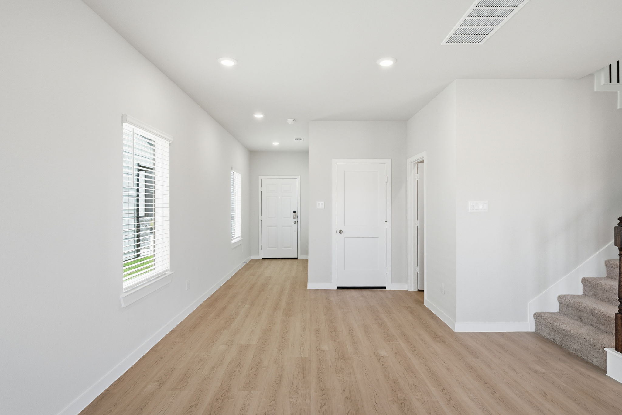 A room with white walls and a wood floor.